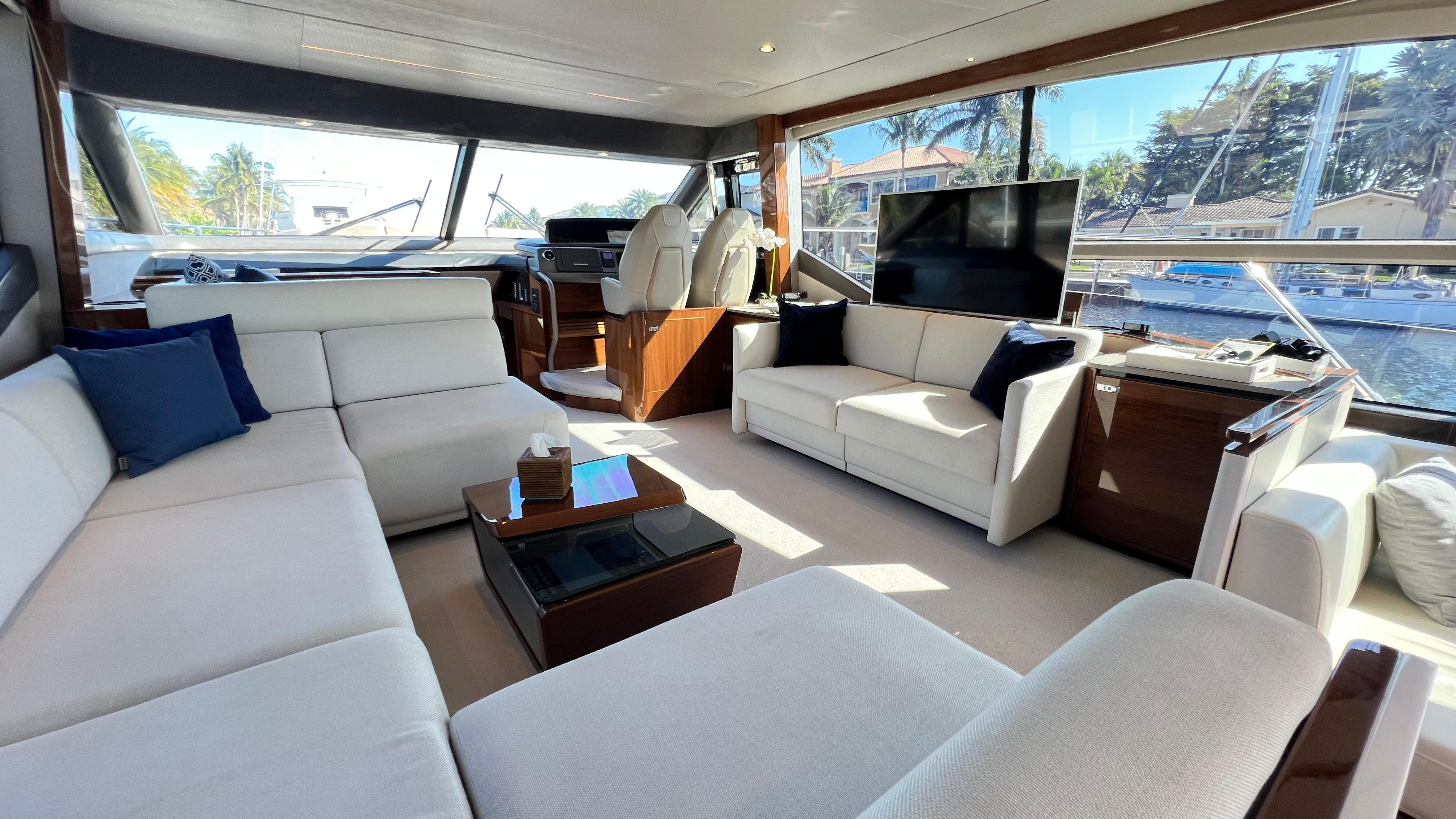 Luxurious interior of 2019 Princess F62 yacht with elegant seating and large windows.
