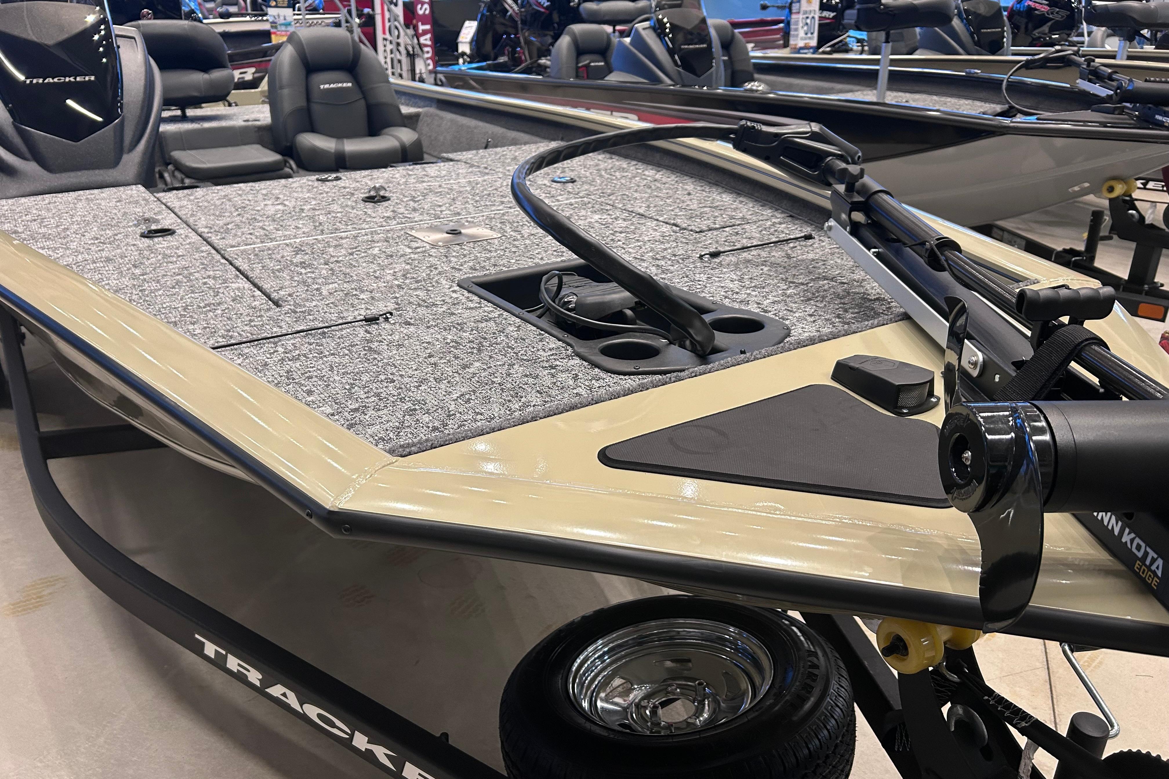 2026 Tracker Pro Team 195 boat with spacious deck and seating, displayed indoors.