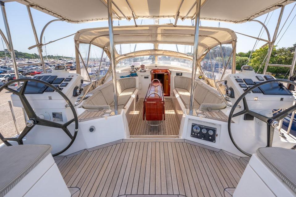 Luxurious 2011 Discovery 67 yacht cockpit with dual steering wheels and elegant seating.