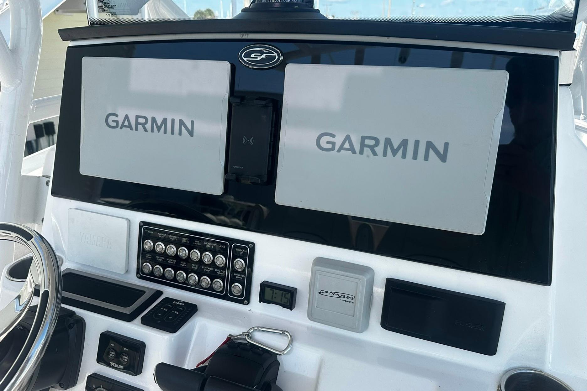 Dashboard of a 2002 Sea Fox 228 Commander with Garmin navigation displays.