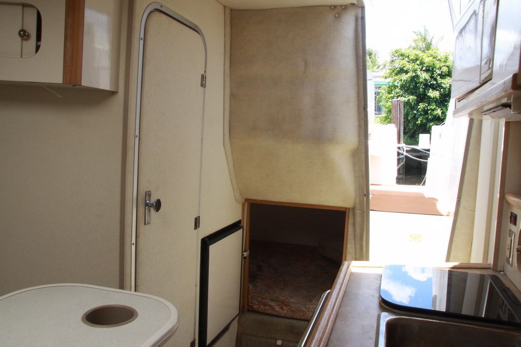 Interior of 1999 Maxum 2400 Mercruiser boat with kitchen and sleeping area.