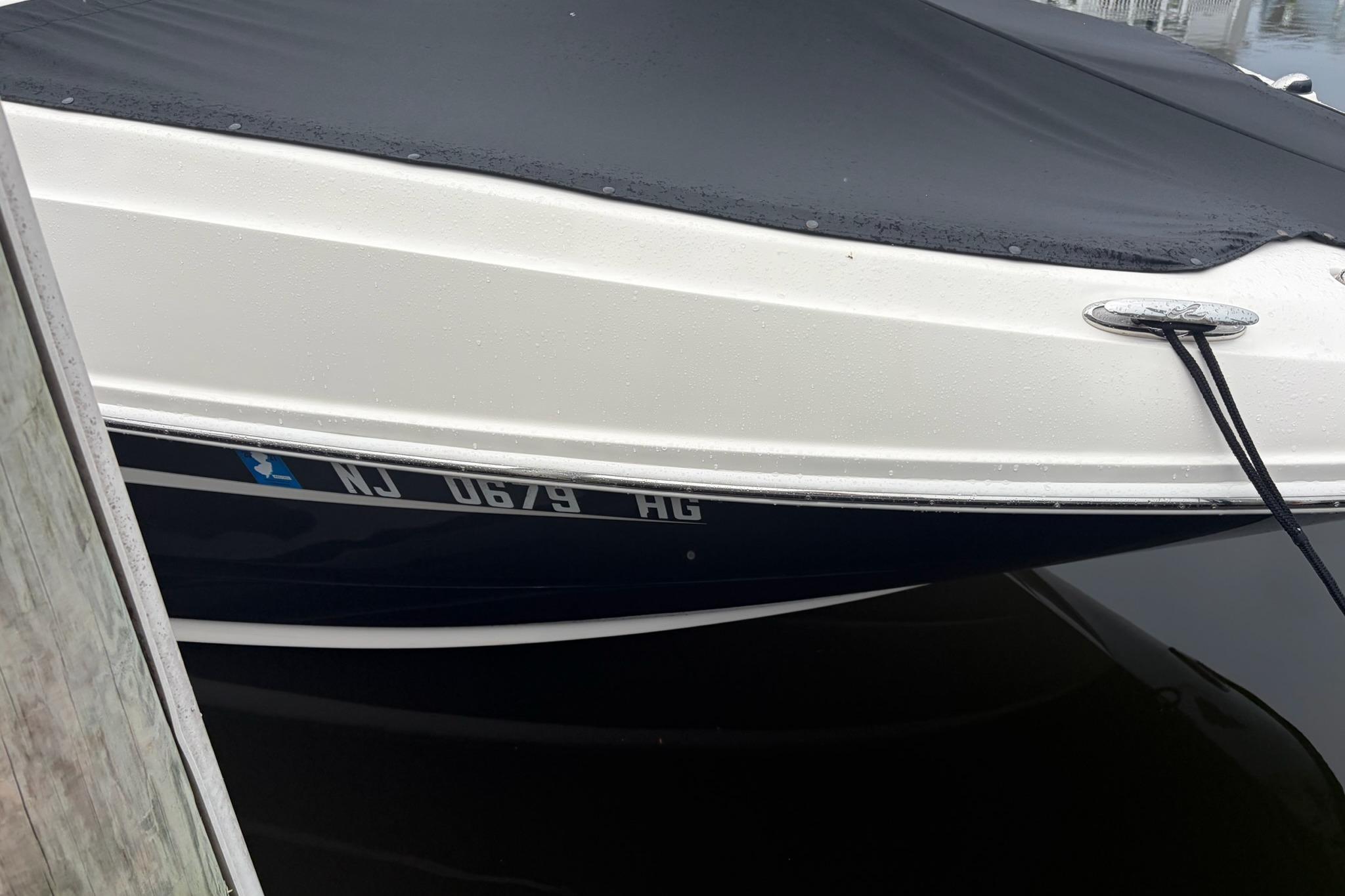 2014 Sea Ray 260 Sundeck boat docked with cover, registration NJ 0679 HG.