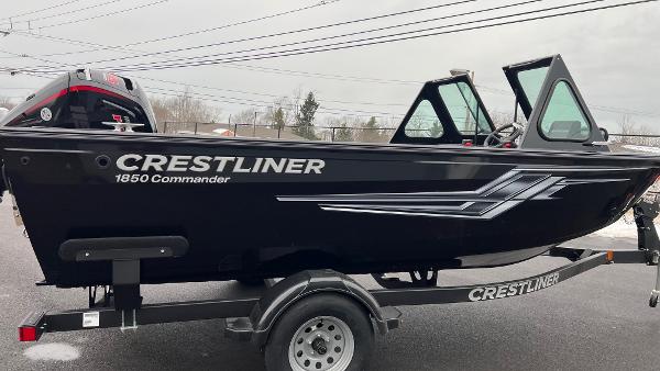2025 Crestliner 1850 Commander boat on trailer, black exterior, side view.