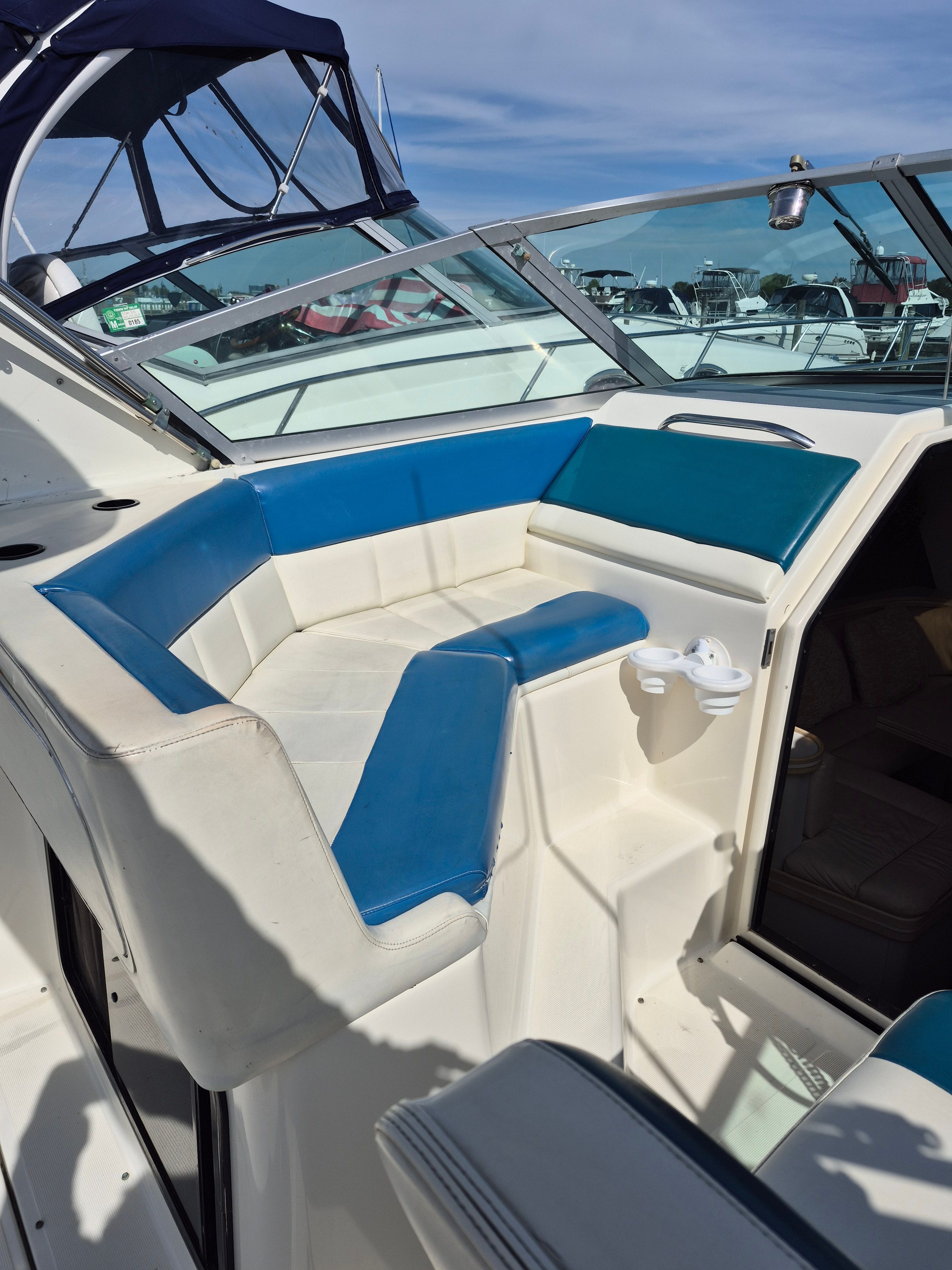 The image shows a boat seating area with blue and white upholstery.