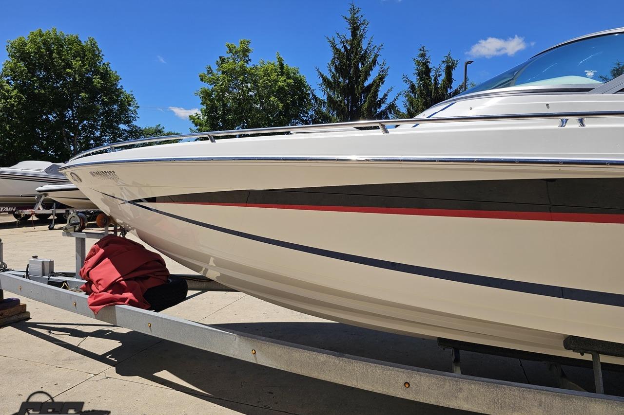 2005 Formula 271 FASTech boat on trailer, sunny day, trees in background.