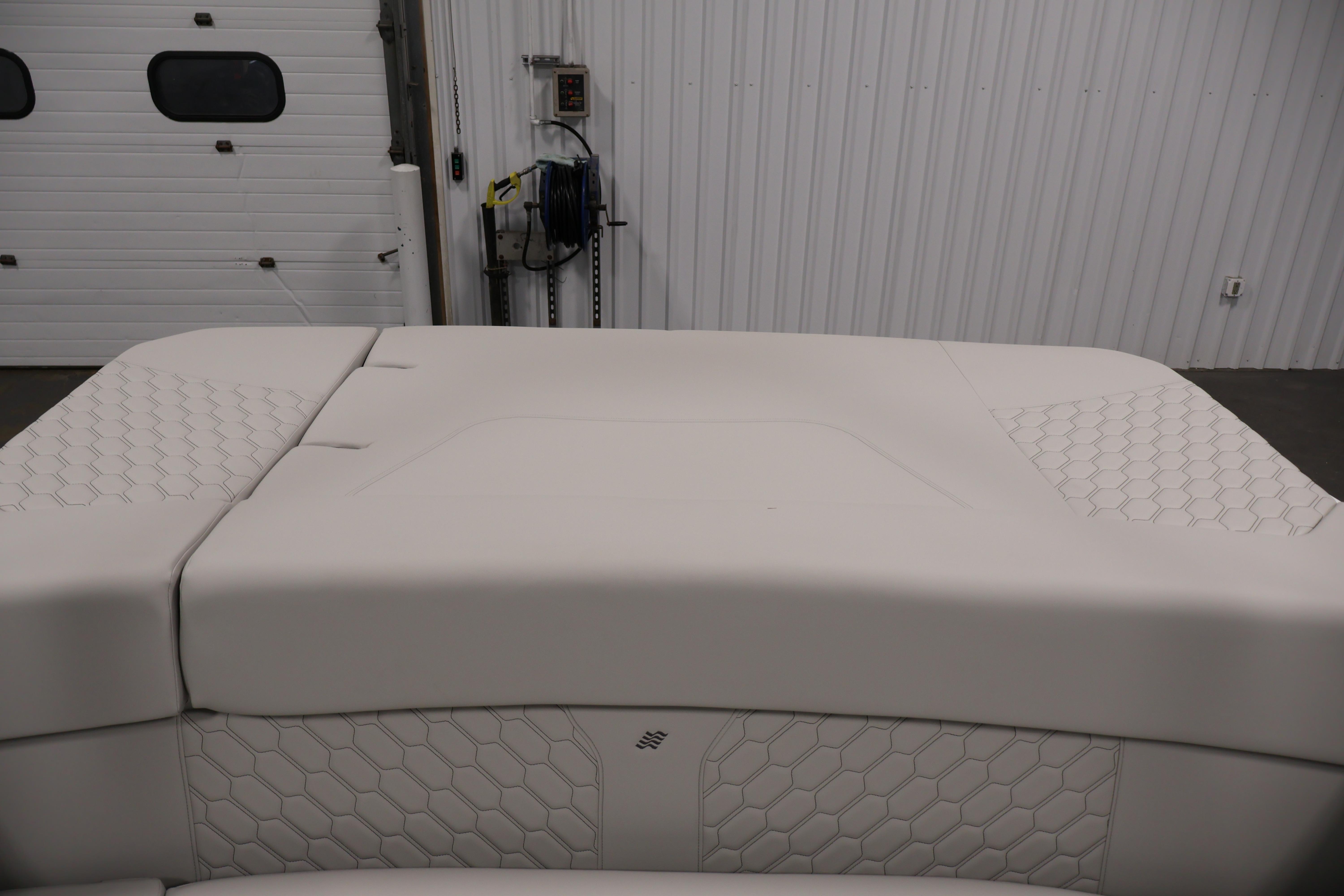 2026 Four Winns H4 Freedom boat interior with white cushioned seating.