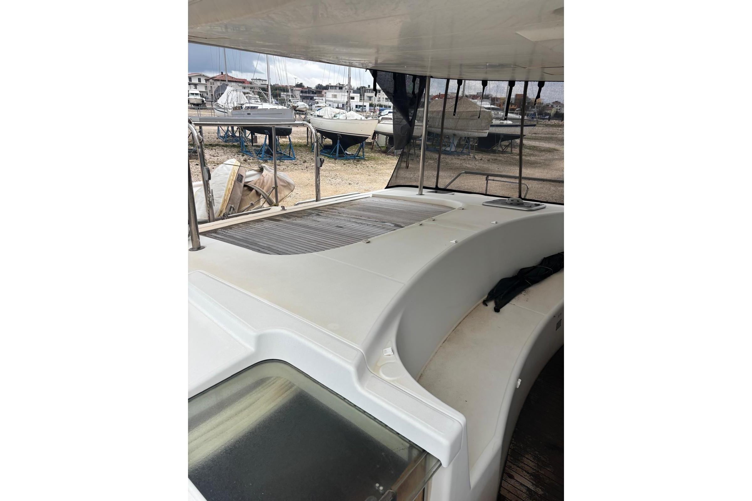 2007 Lagoon Power 44 boat interior with covered seating area and marina view.