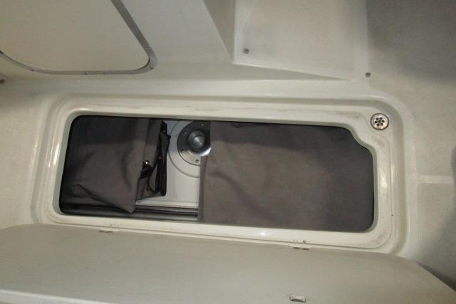 Storage compartment in a 2004 Stingray 240 LR boat interior.