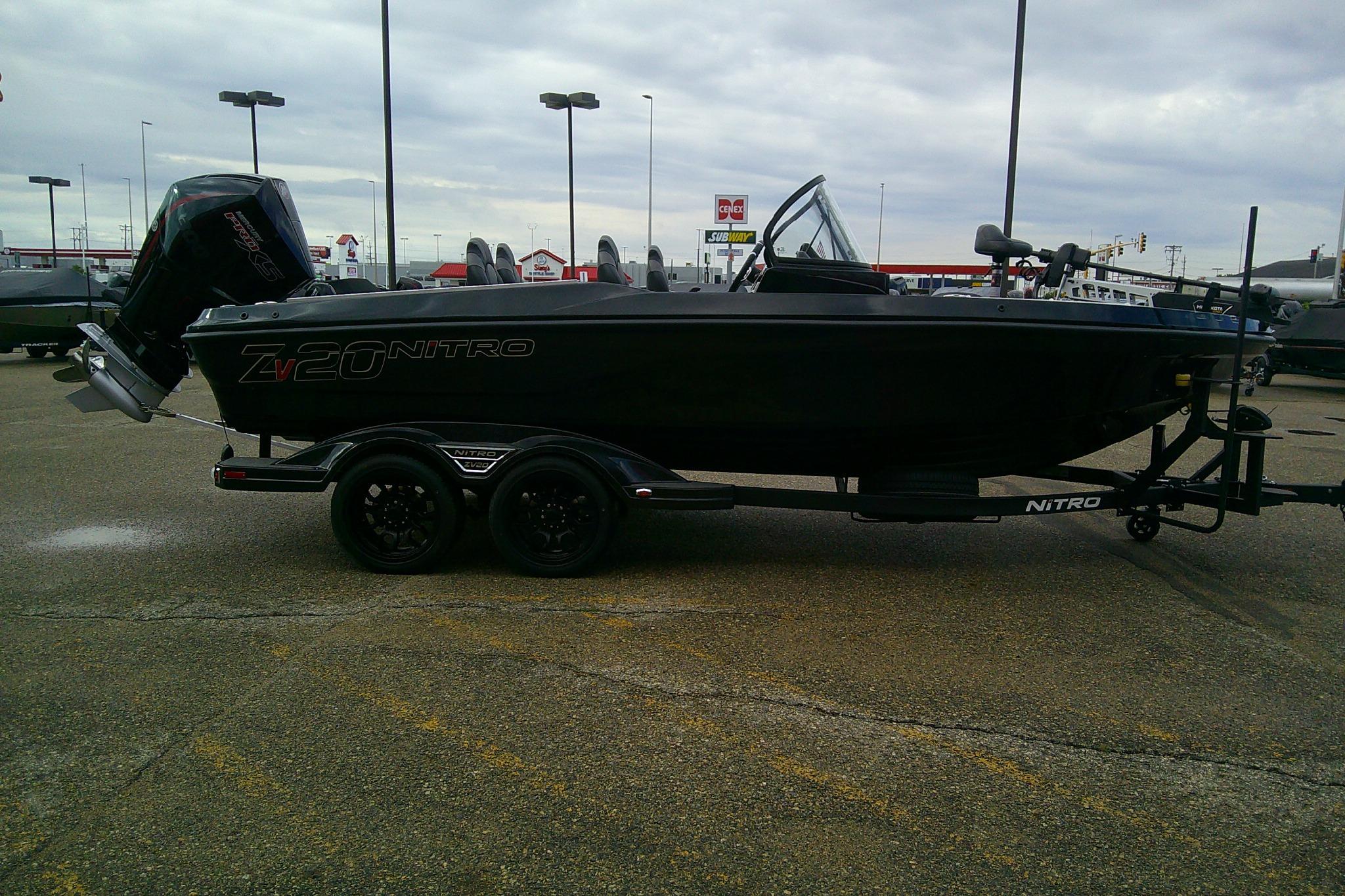2026 Nitro ZV20 boat on trailer in parking lot, overcast sky.