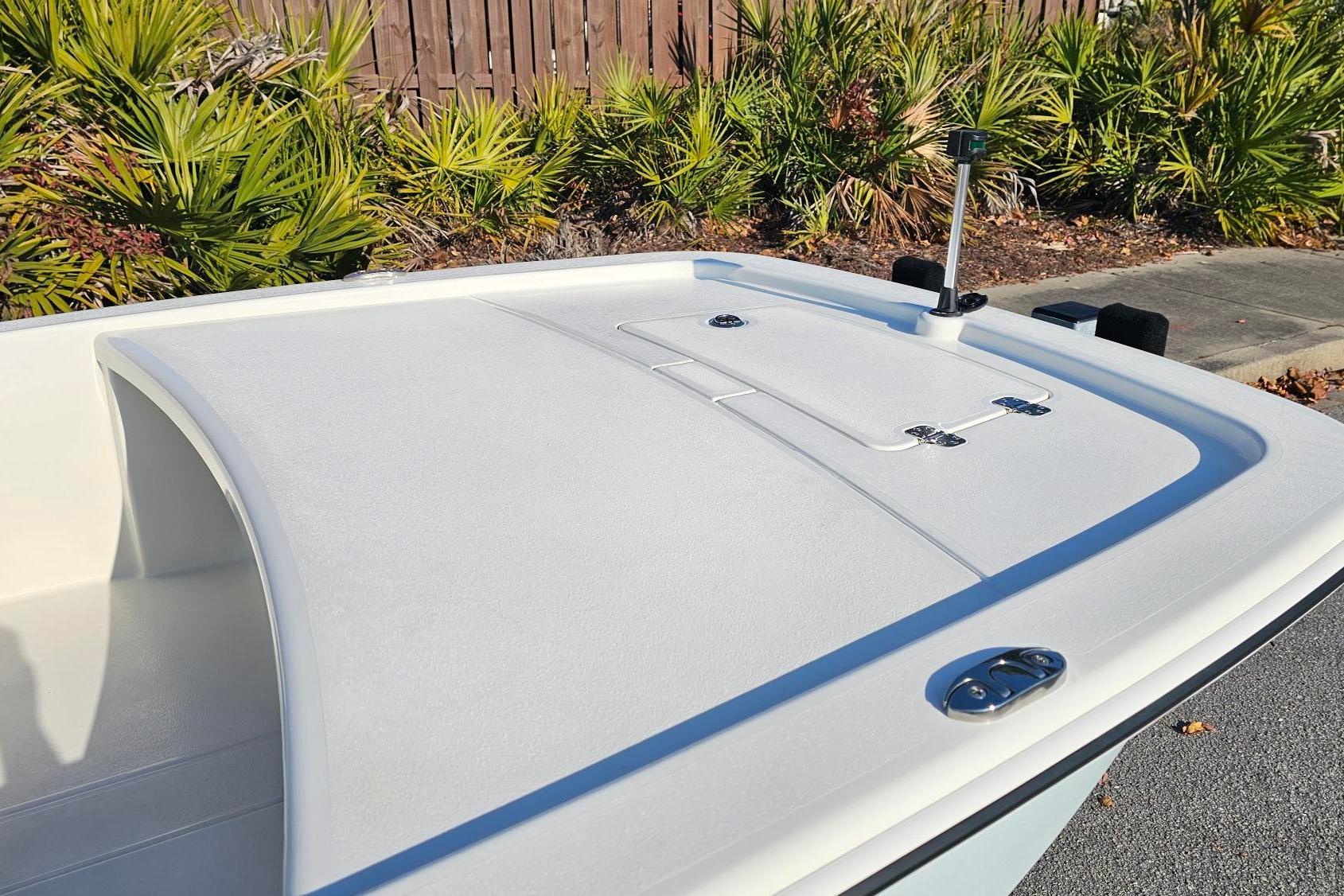 2026 Mako Pro Skiff 13 CC boat deck with storage compartments and sleek design.