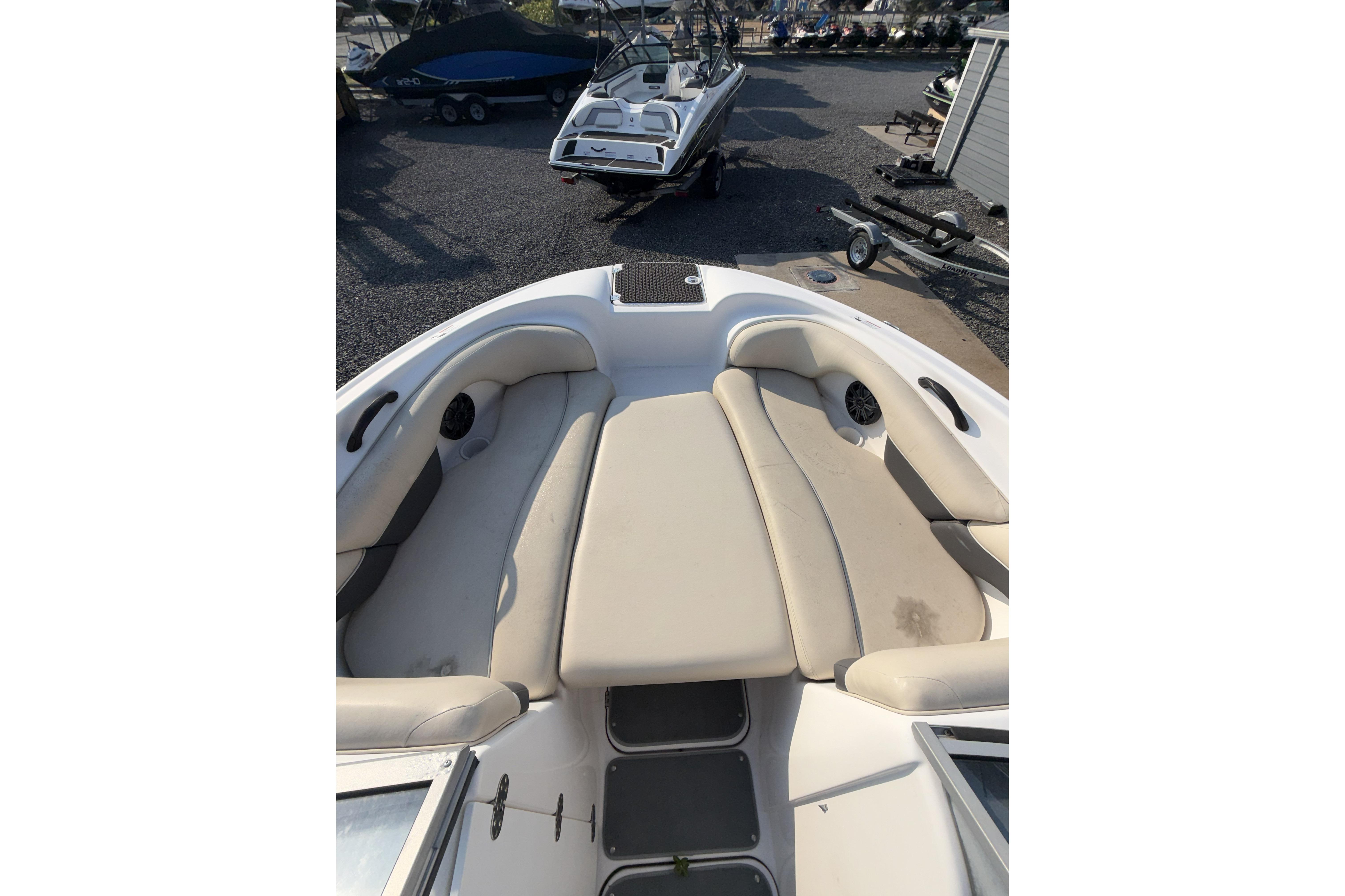 2006 Yamaha Boats SX210 interior with beige seating and storage compartments.