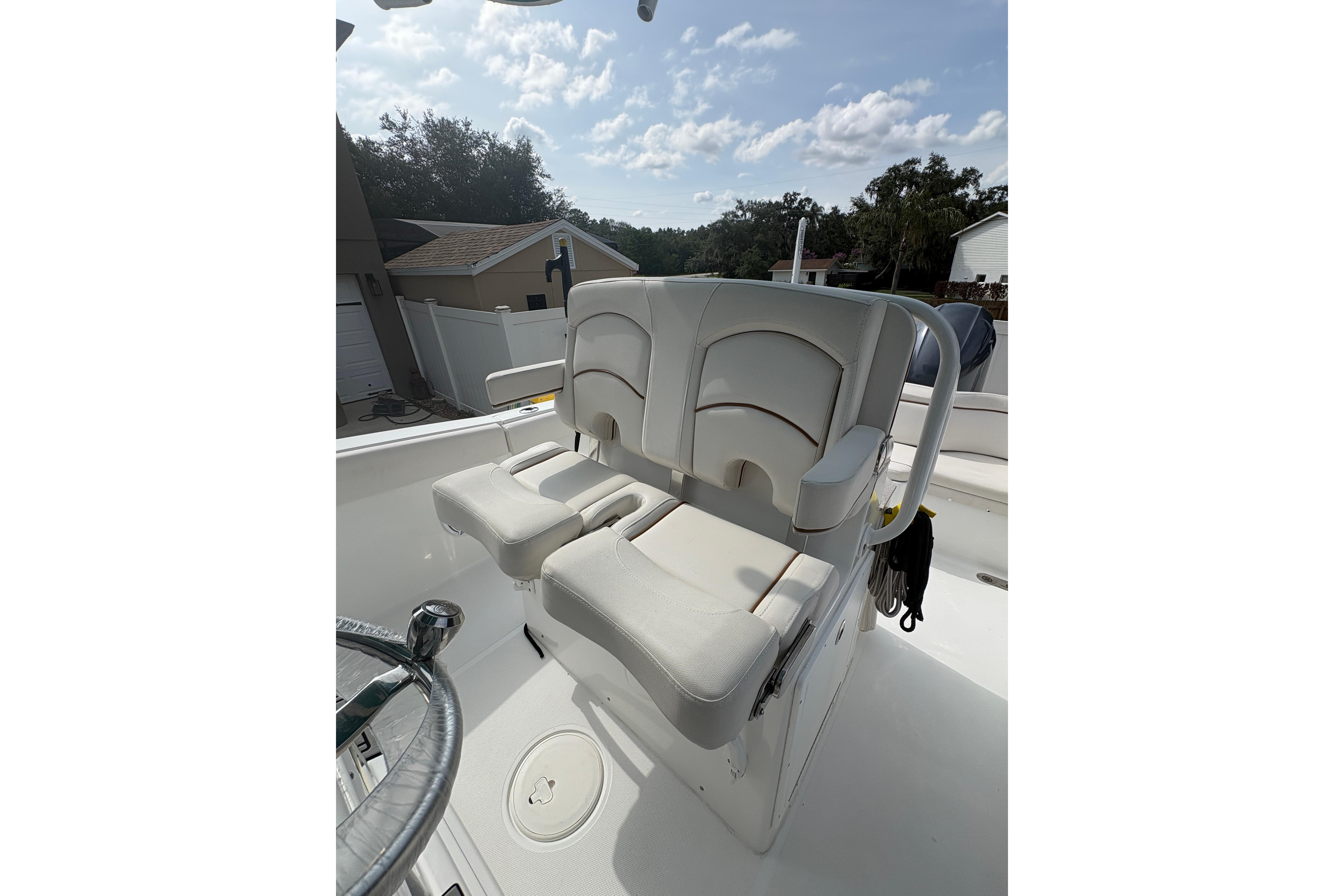 2021 Sea Hunt Ultra 265 SE boat with dual cushioned seats and steering wheel.