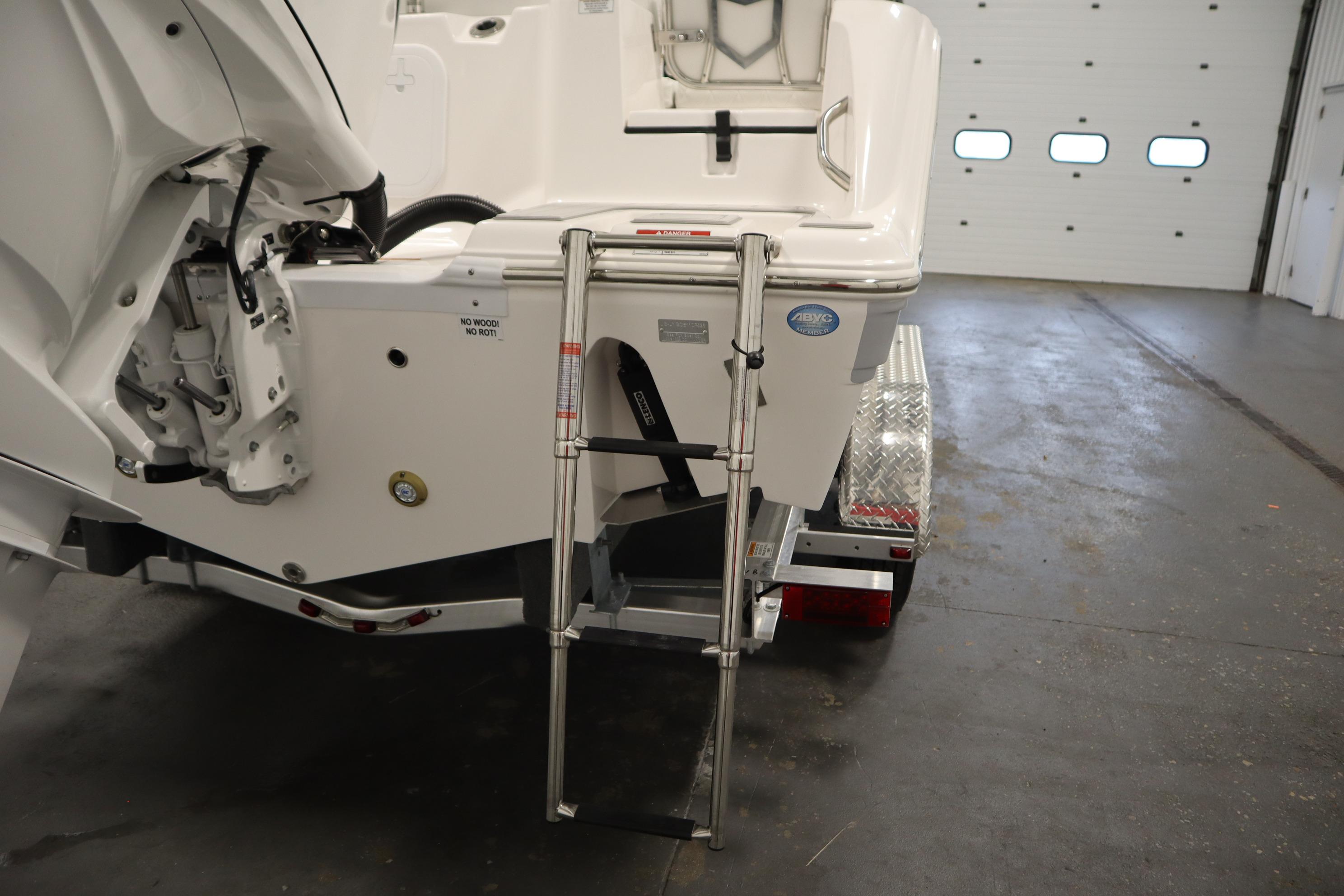 2026 Sea Fox 228 Commander boat with ladder and trailer in a garage.
