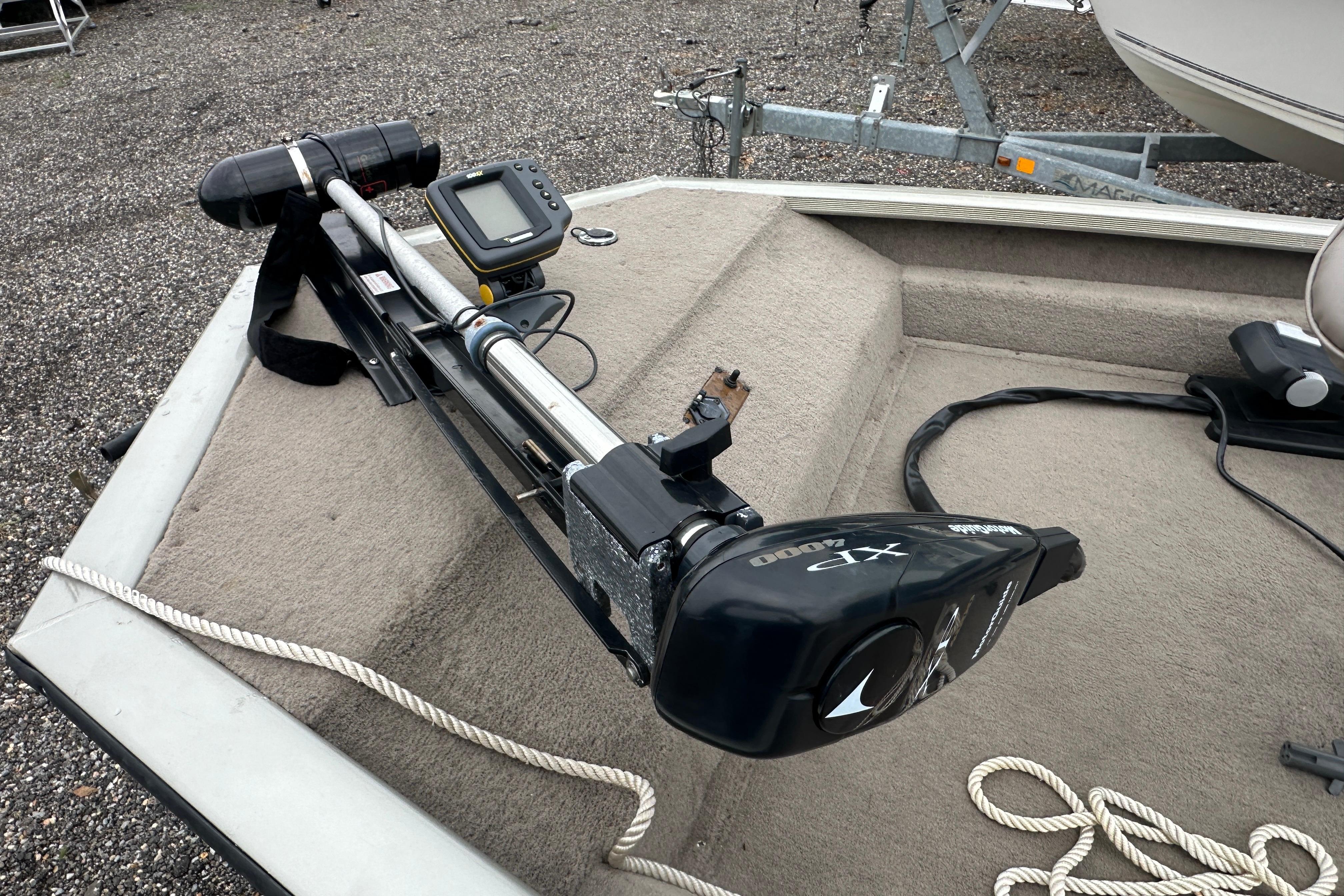 Trolling motor and fish finder on a 2002 Fisher 1710 boat deck.