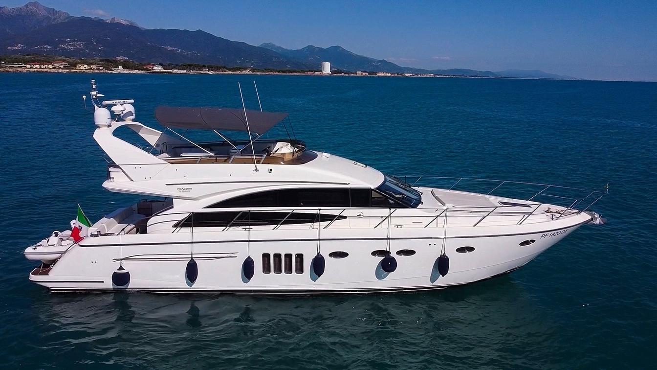 2010 Princess 62 Flybridge yacht cruising on blue ocean waters.