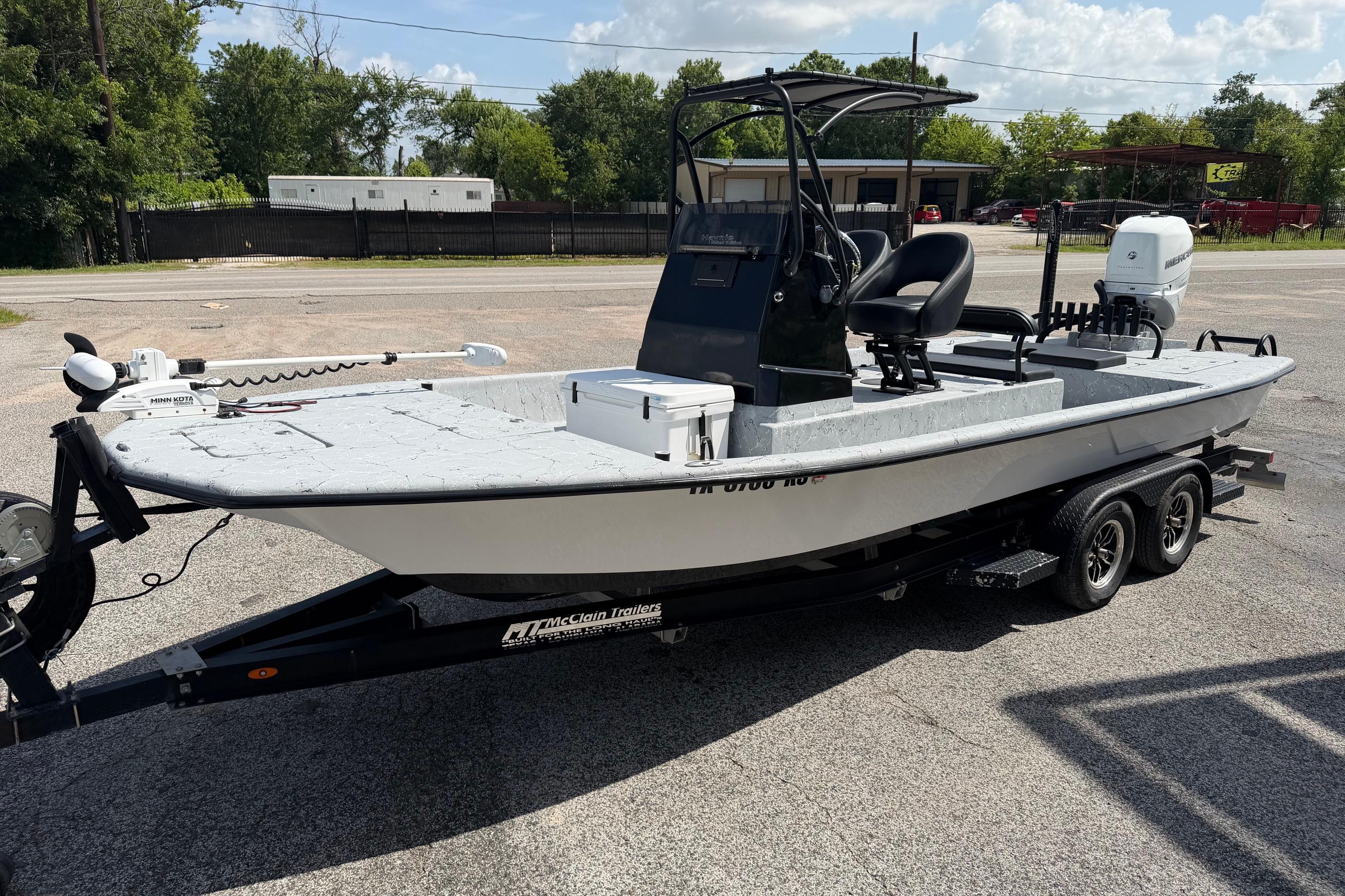 2023 Haynie 23 Super Cat boat on trailer, parked outdoors.