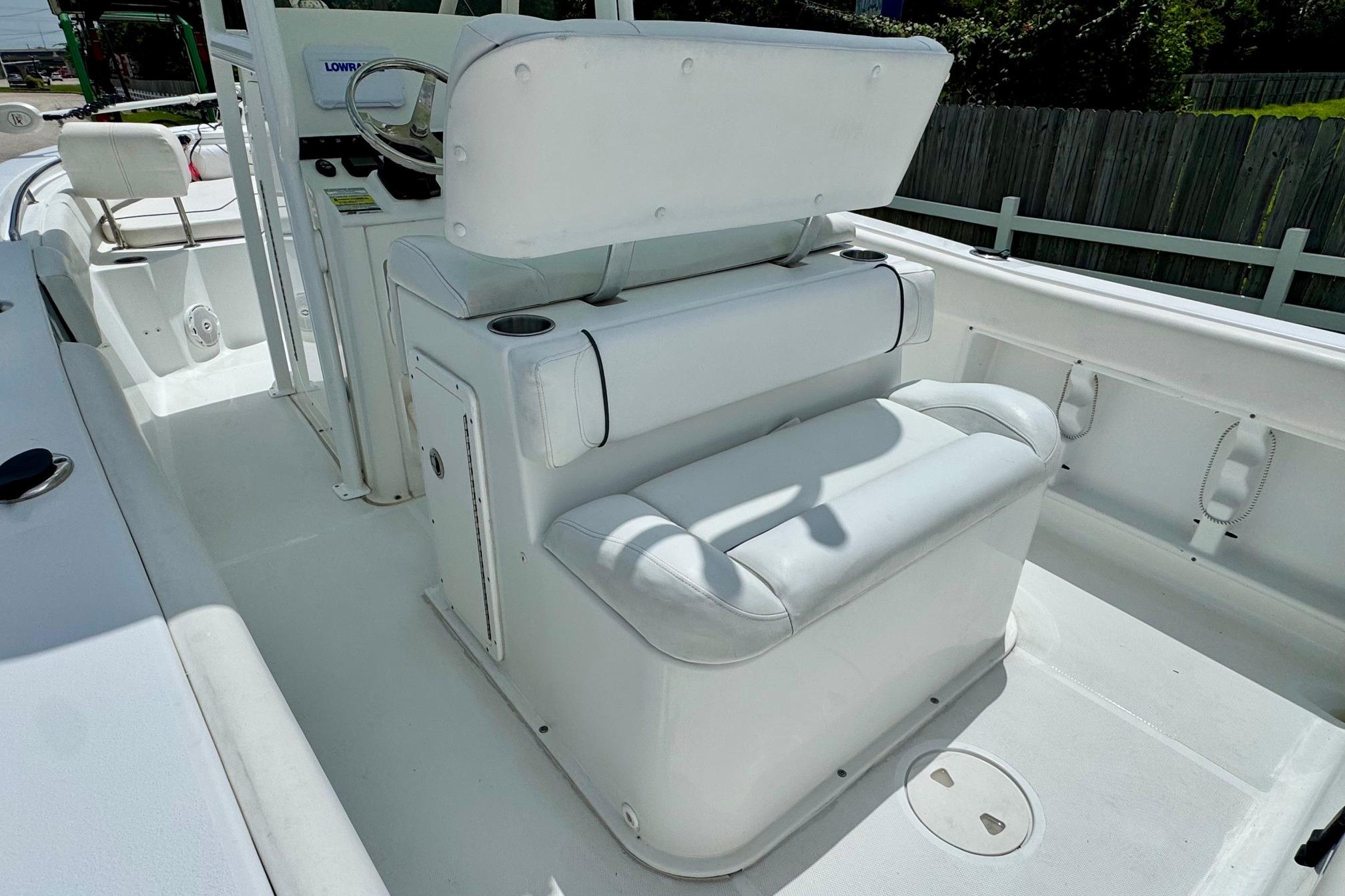 2015 Sea Hunt Ultra 234 boat interior with white seating and steering console.