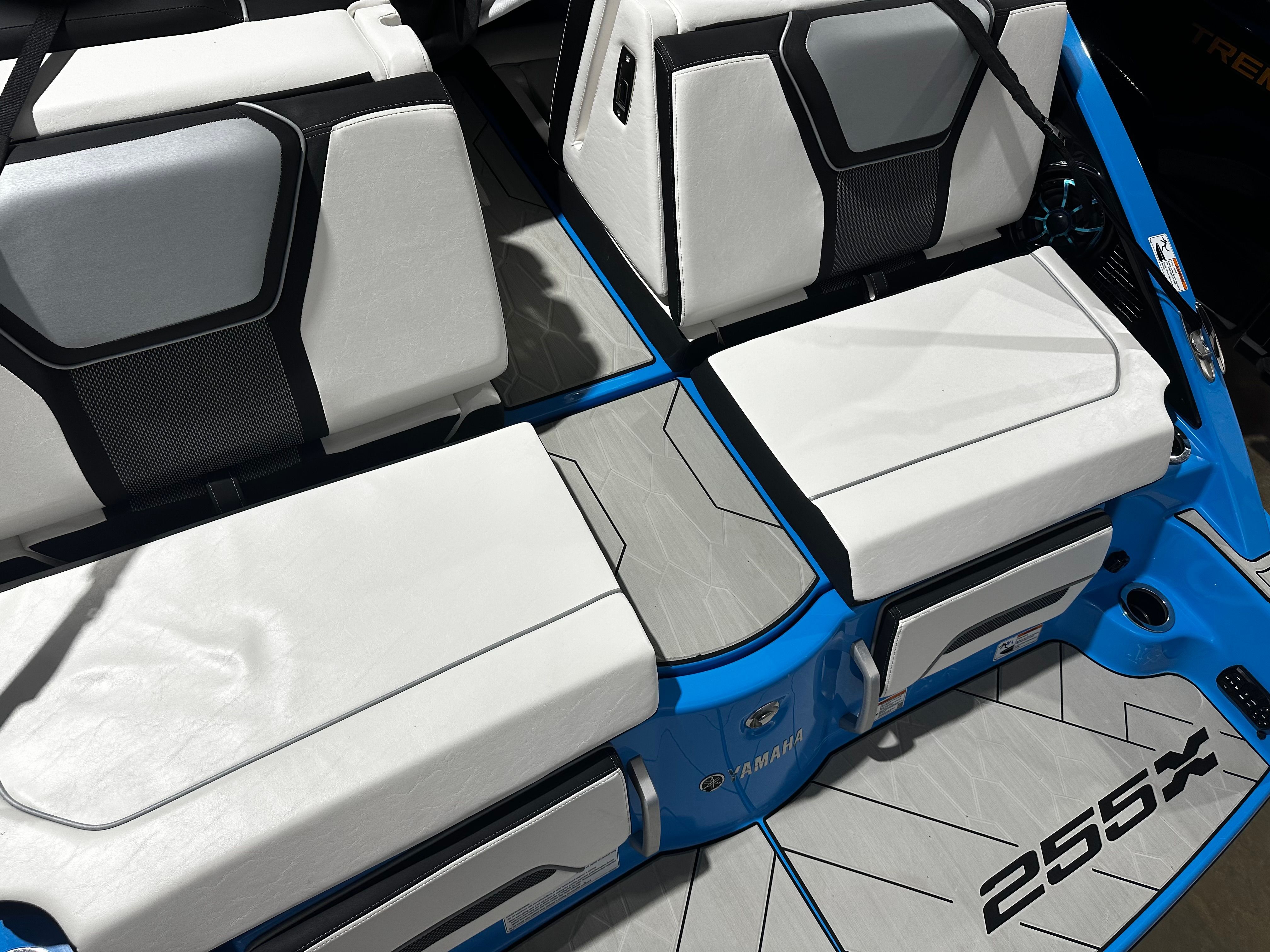 2023 Yamaha Boats 255XD interior with white seating and blue accents.