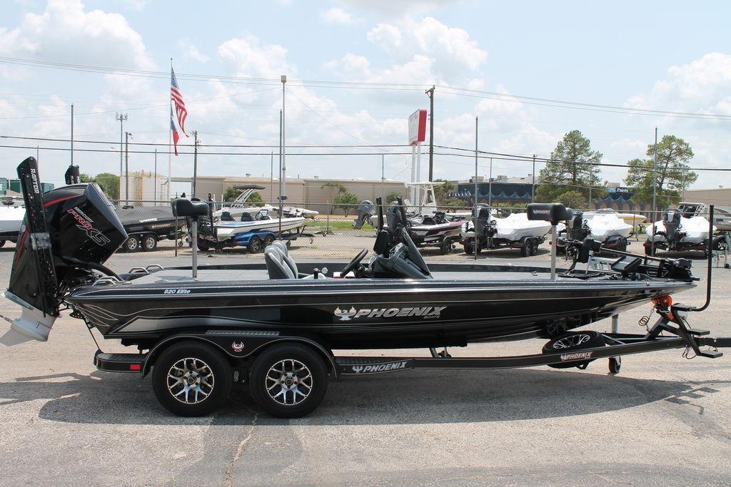 2025 Phoenix 920 Elite boat on trailer in dealership lot, side view.
