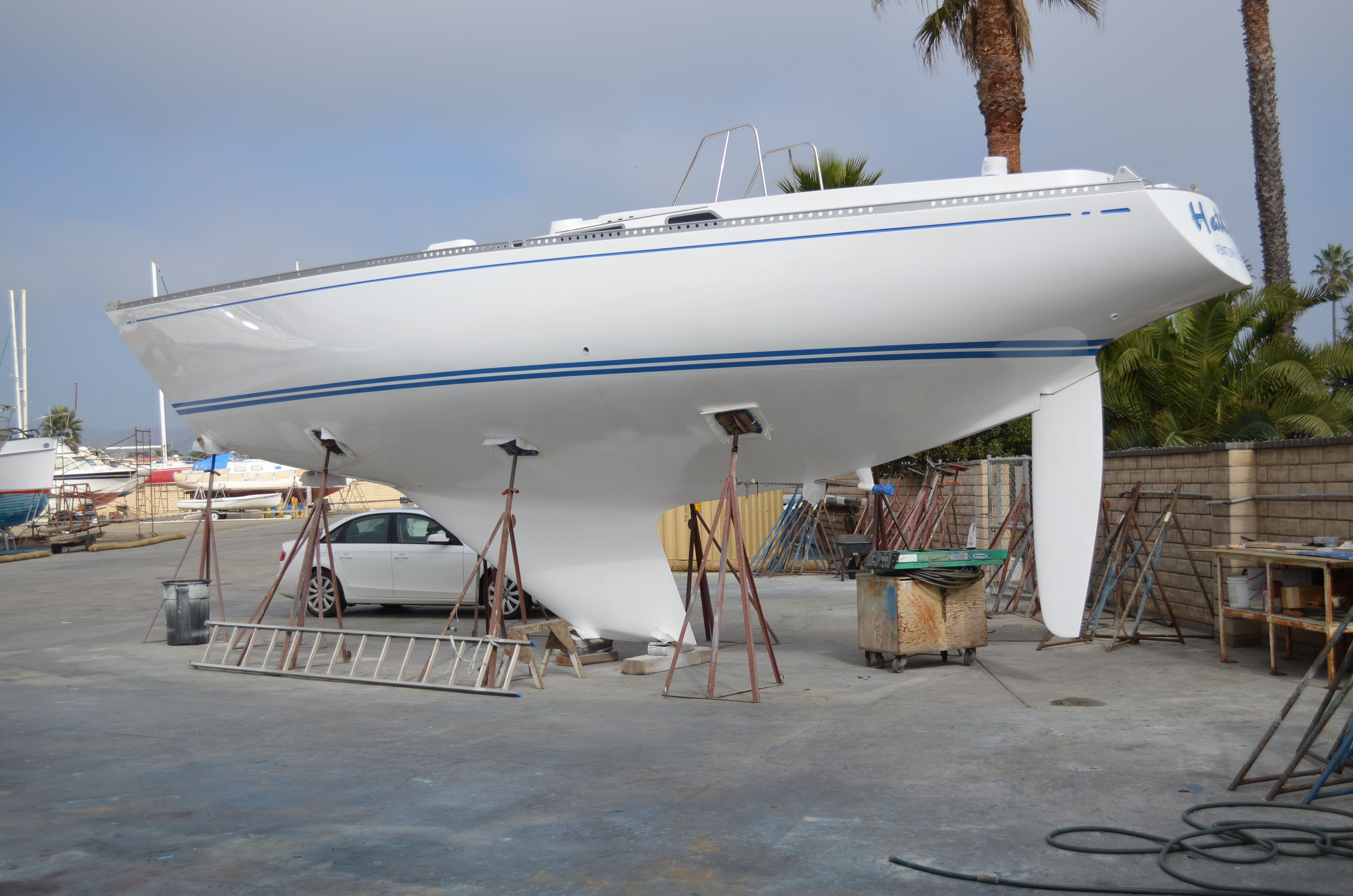 A 1972 Nautor Swan S & S 44 is propped up in a boatyard area.