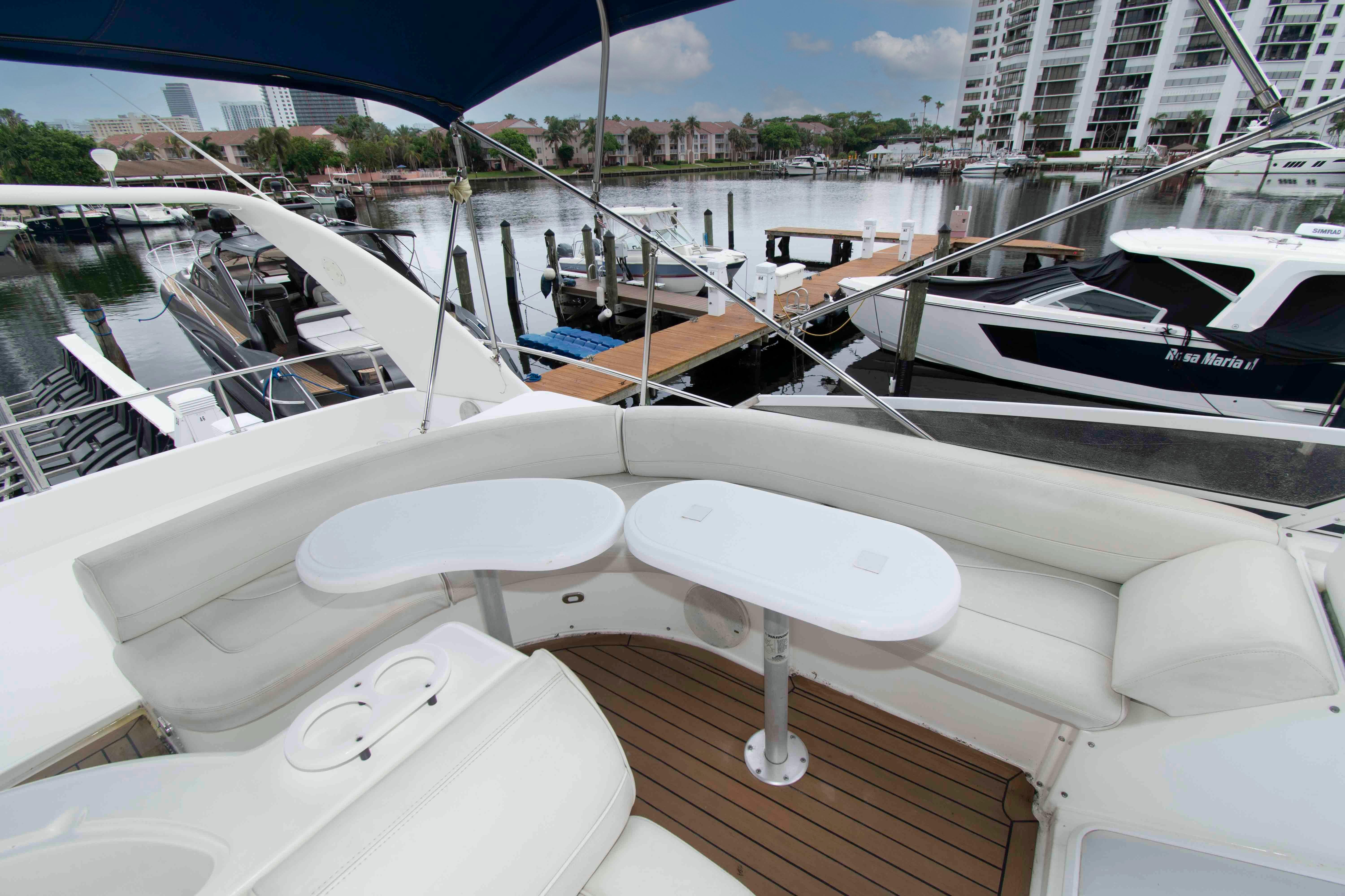 Luxury seating area on 2000 Cruisers Yachts 5000 Sedan Sport at marina.