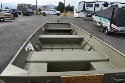 2025 Lowe L1240 Jon boat in a parking lot, surrounded by vehicles and trailers.