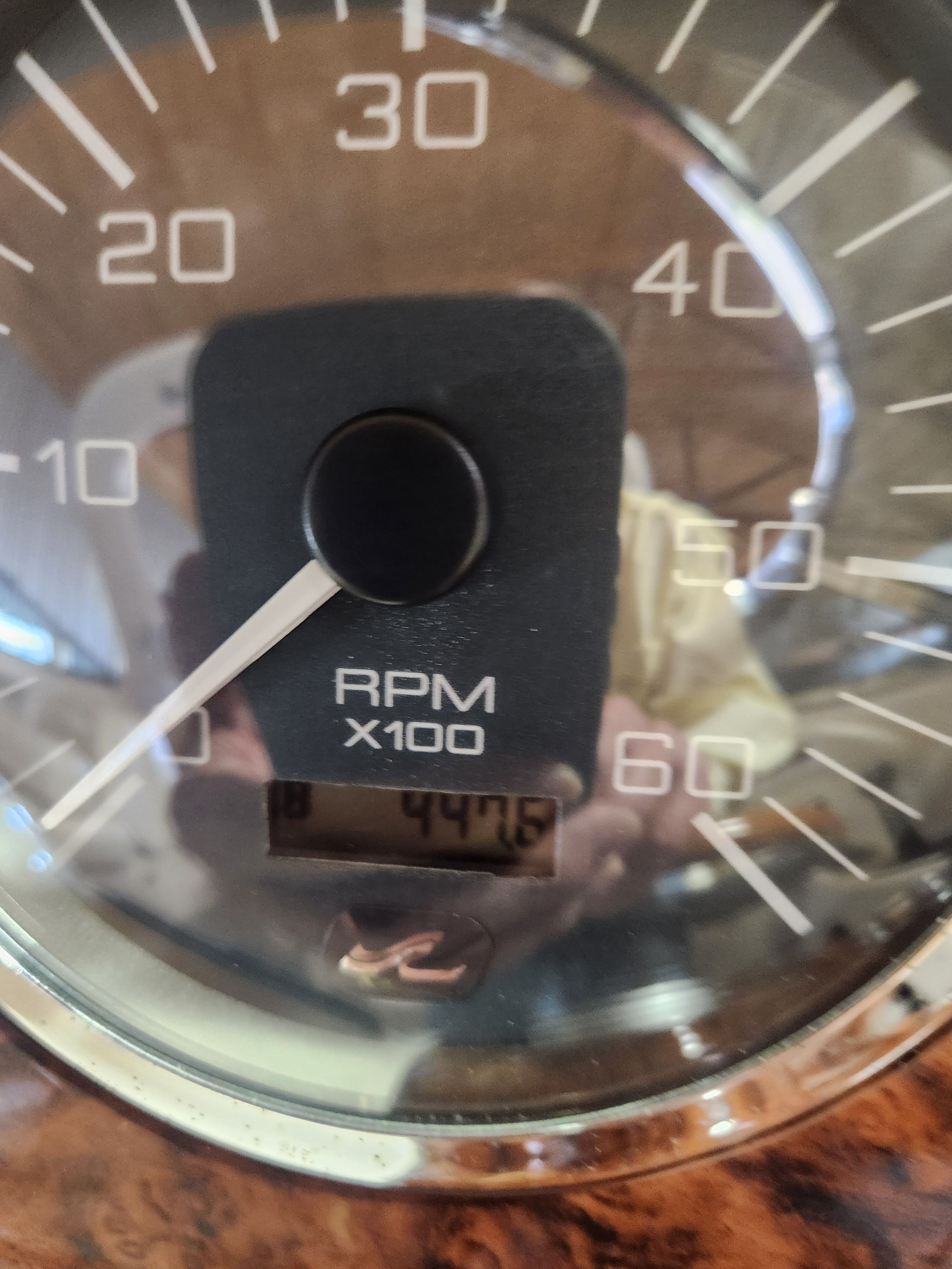 Close-up of a tachometer showing 447.5 RPM x100.