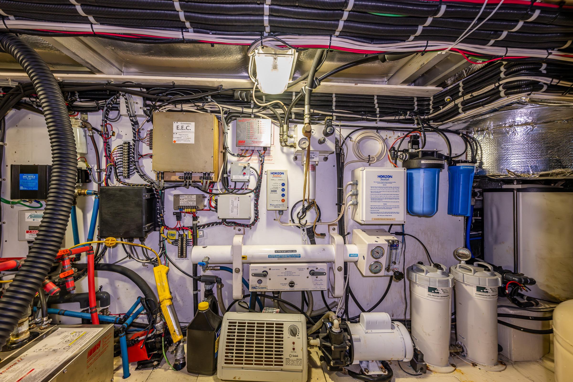 Engine room of a 2001 Navigator Pilothouse yacht with complex wiring and equipment.