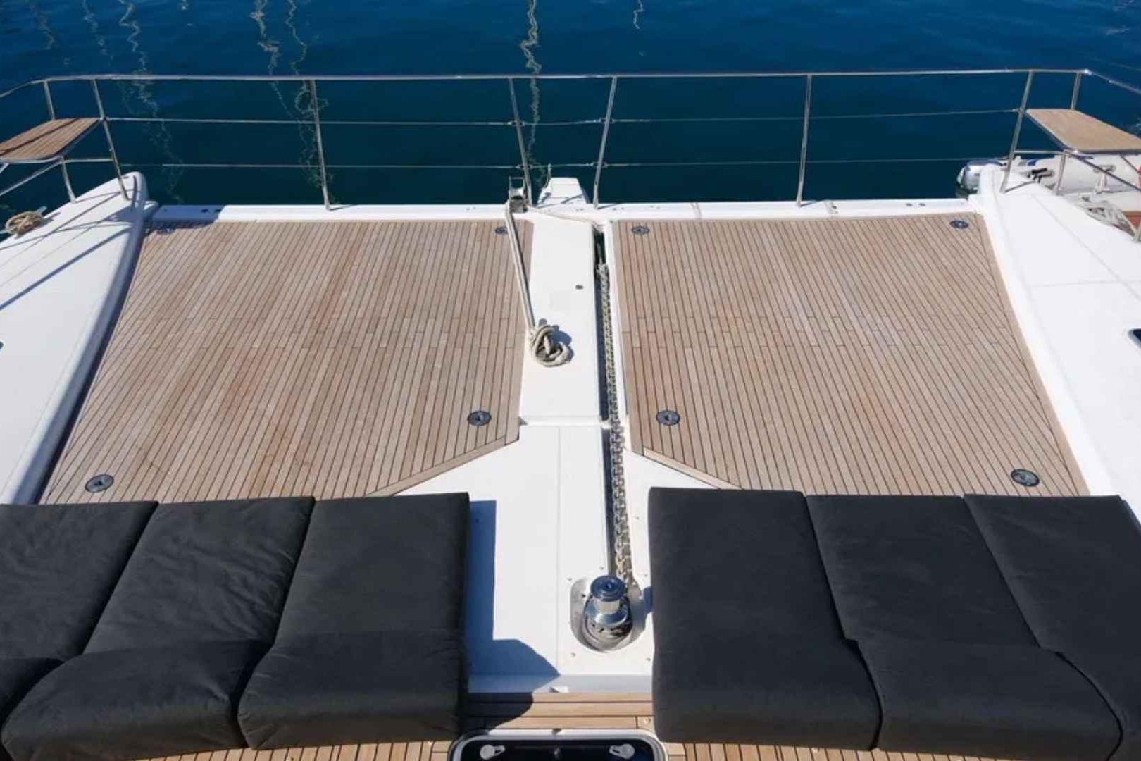 Luxurious deck of 2020 Lagoon 630 Motor Yacht with cushioned seating and ocean view.