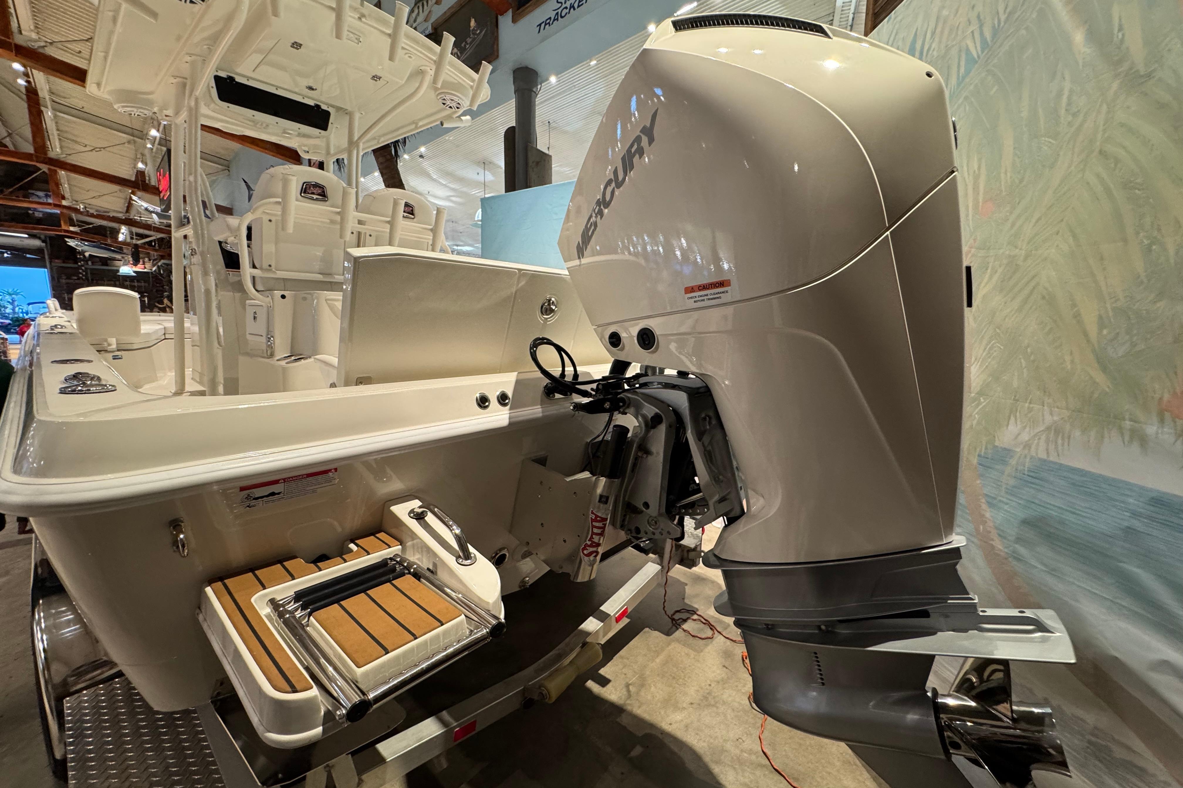 2025 Ranger 2360 Bay boat with Mercury outboard engine, showcased indoors.