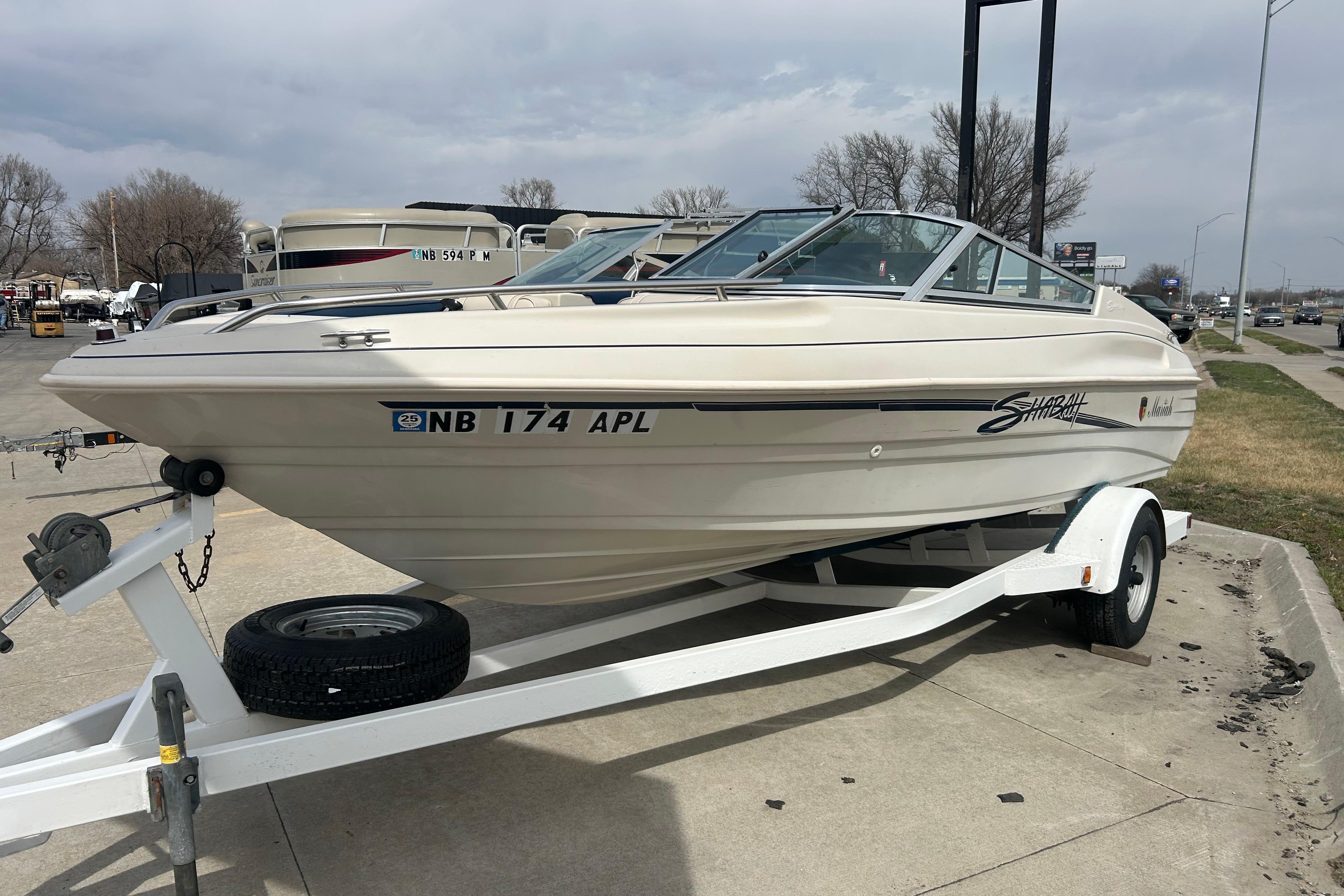 1996 Mariah 180 Shabah boat on trailer, parked outdoors on a cloudy day.