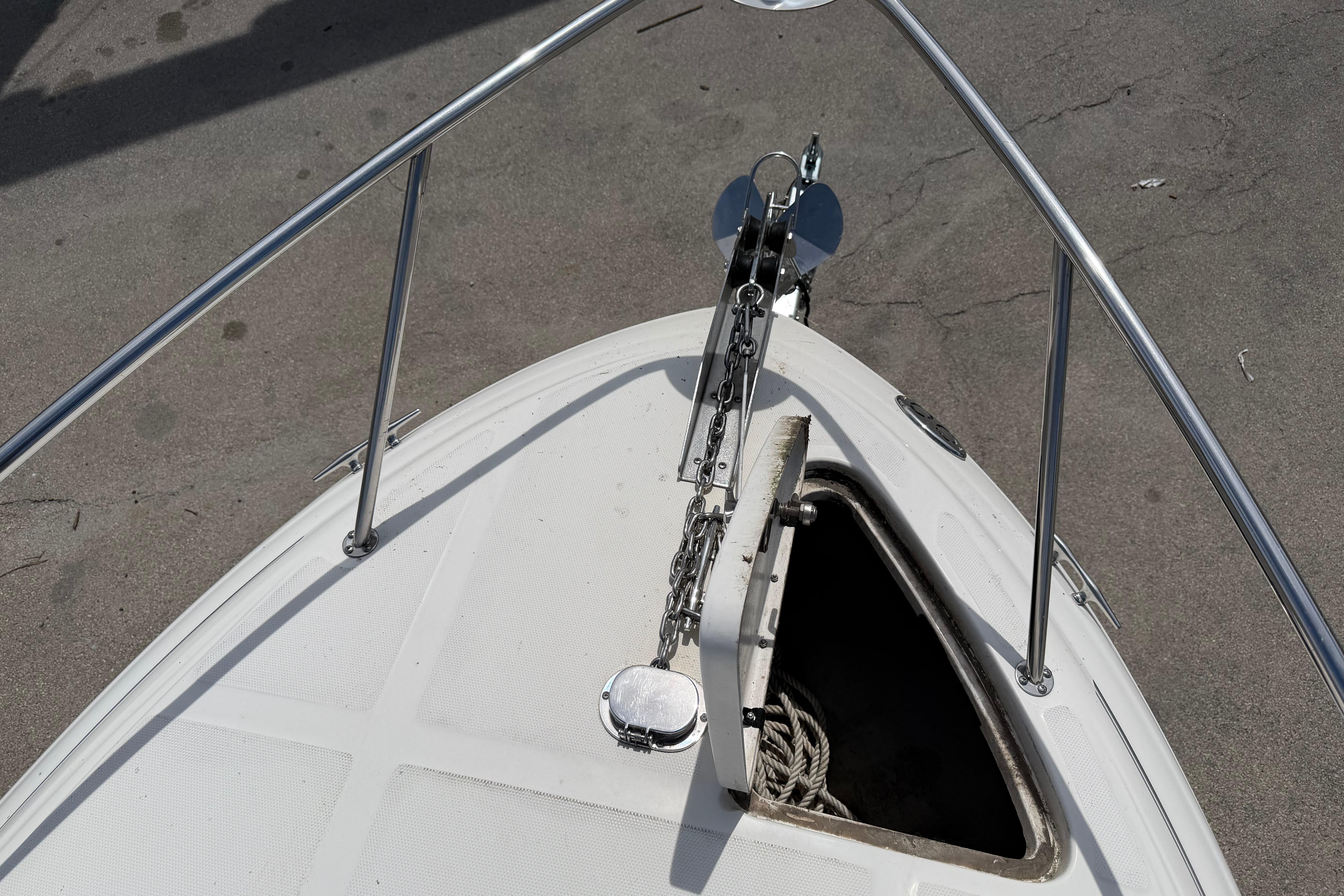 Bow view of 2004 Sea Ray Sundancer 260 with anchor and open hatch.