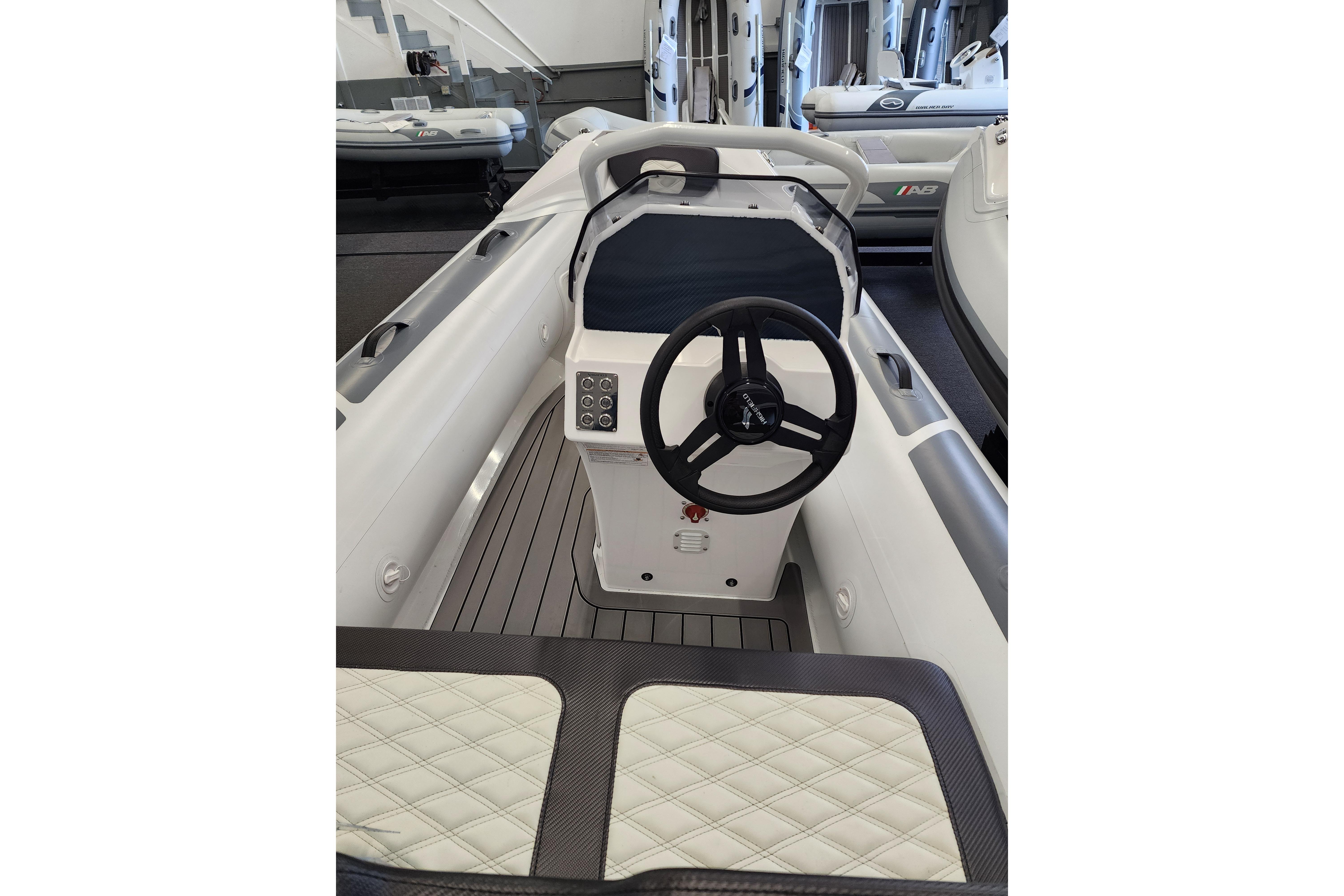 2025 Highfield Sport 390 boat interior with steering wheel and seating.