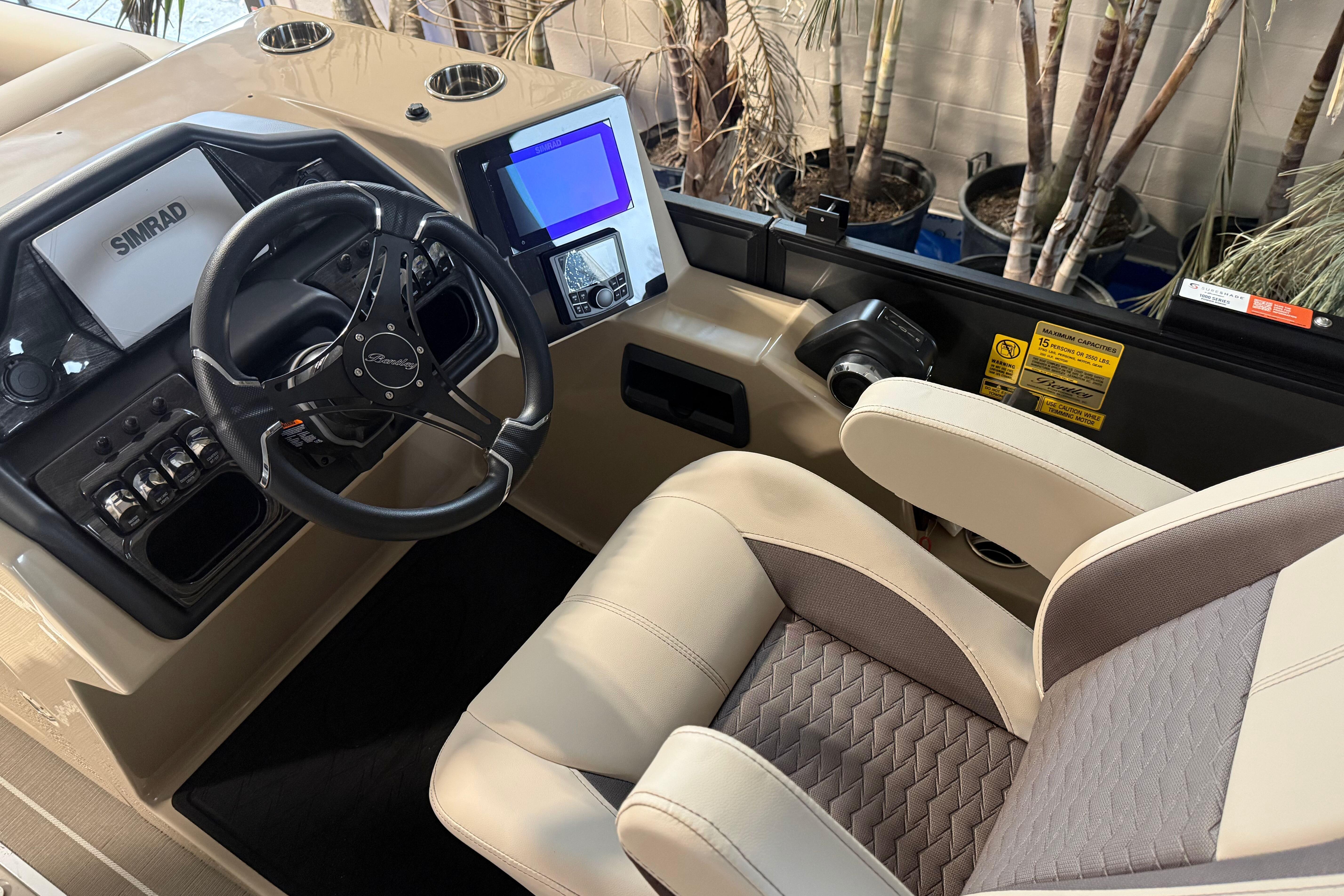 2026 Bentley Pontoons Elite 223 Admiral helm with steering wheel and navigation display.