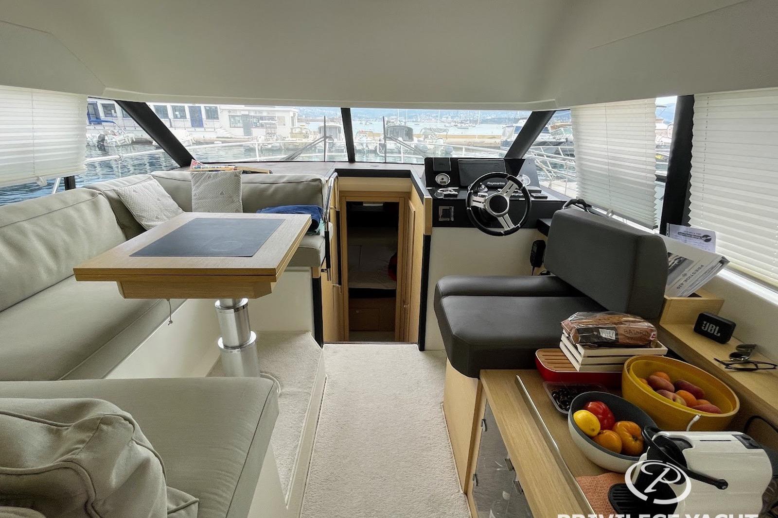 Luxurious interior of a 2016 Prestige 420 yacht with modern seating and helm.