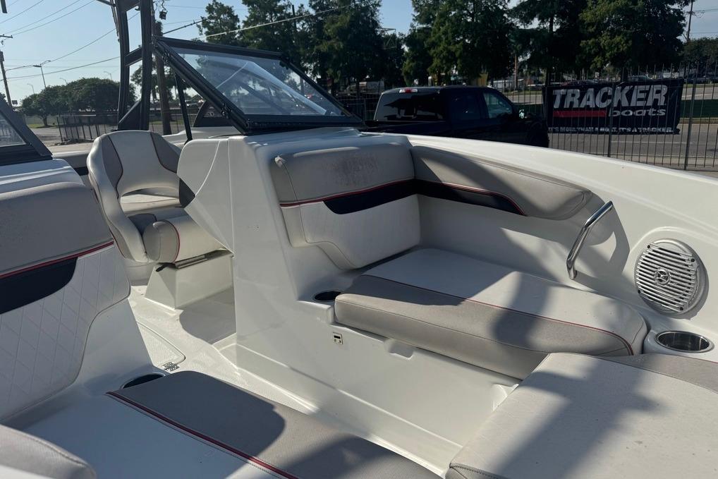 2018 Tahoe 700 TF boat interior with seating and cup holder, parked outdoors.