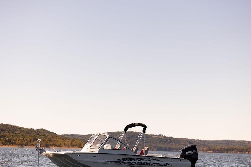2026 SeaArk Dynasty 2.0 boat on a lake with scenic background.