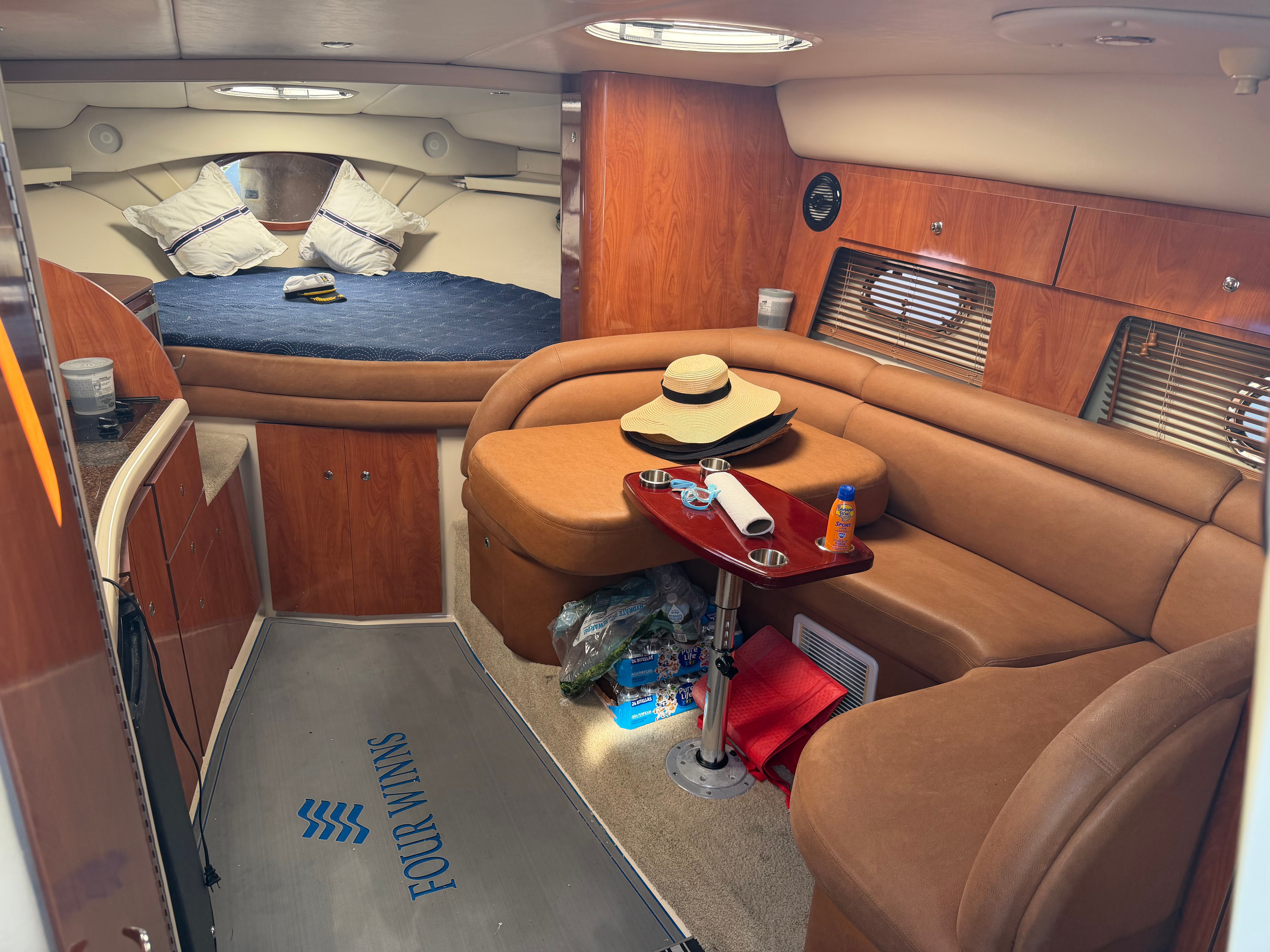 Interior of a 2006 Four Winns 328 Vista yacht with cozy seating area.
