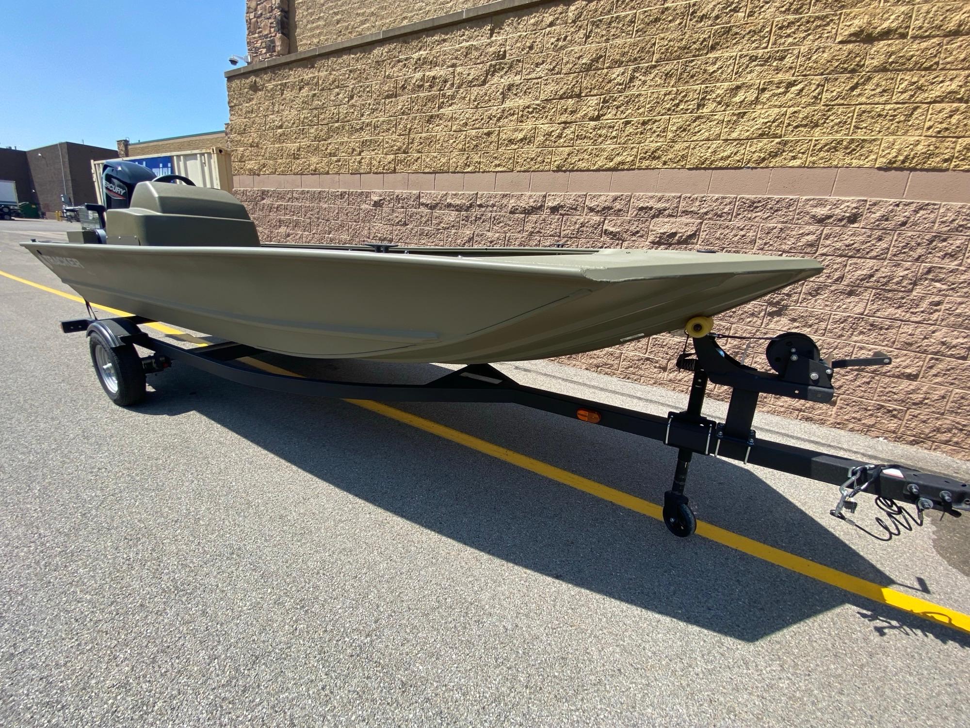 2024 Tracker Grizzly 1648 SC boat on trailer, parked outdoors.