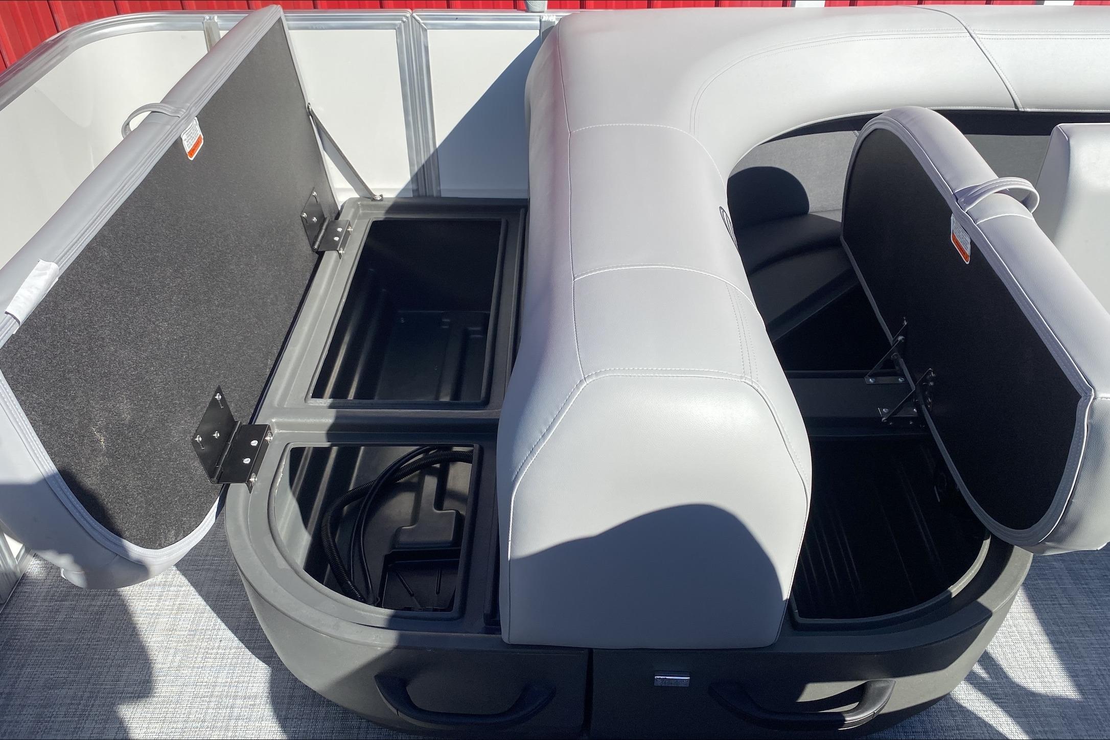2026 Sun Tracker Party Barge 18 DLX seating with open storage compartments.