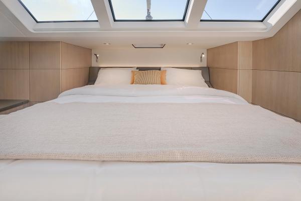 Luxurious bedroom interior of 2025 Privilege Signature 650 yacht with skylights.