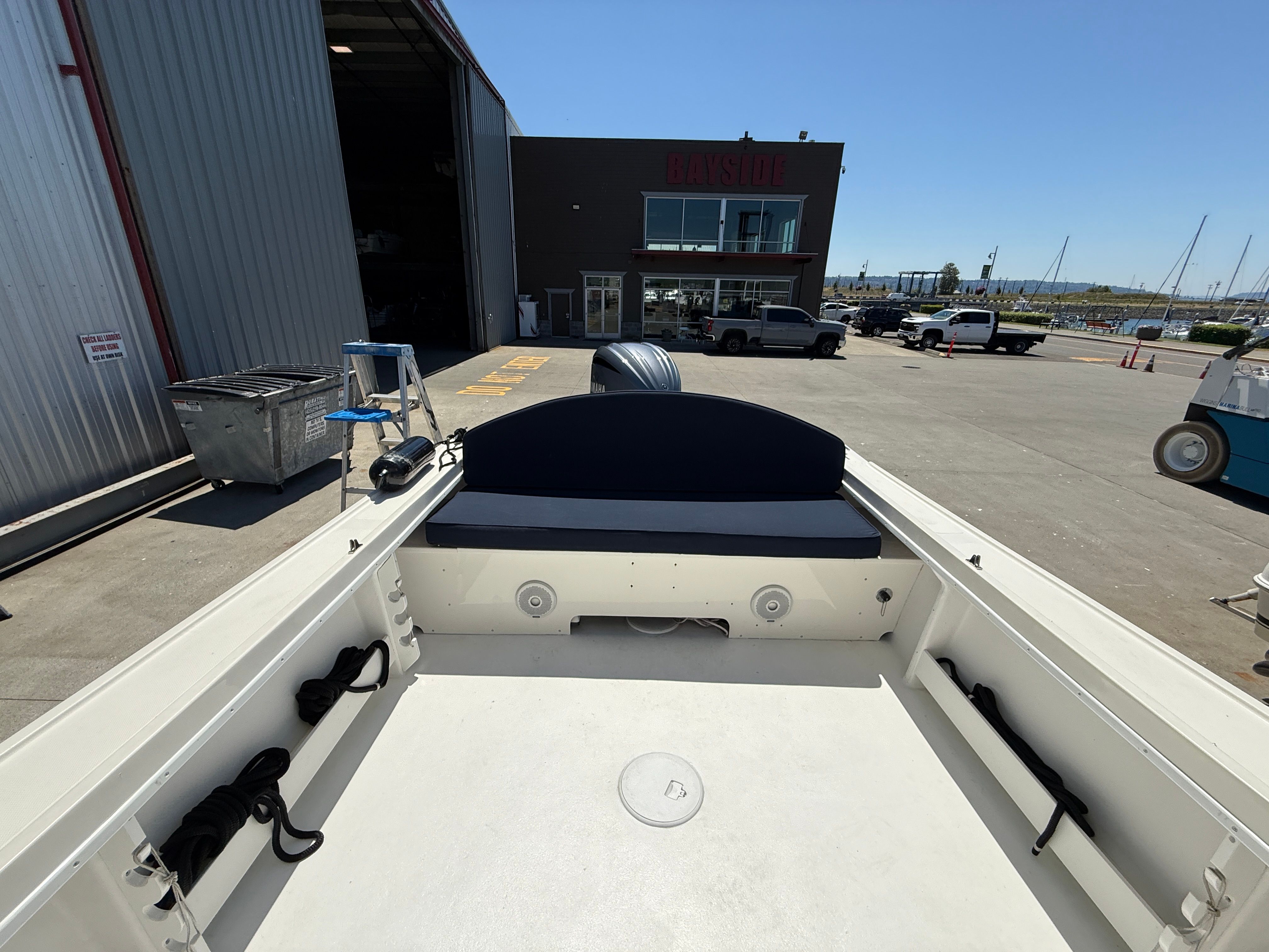 The boat is a 2015 Steiger Craft 255 Chesapeake, parked at a shipyard.