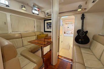 Luxurious 2011 Reliance 44 yacht interior with leather seating and mounted guitar.