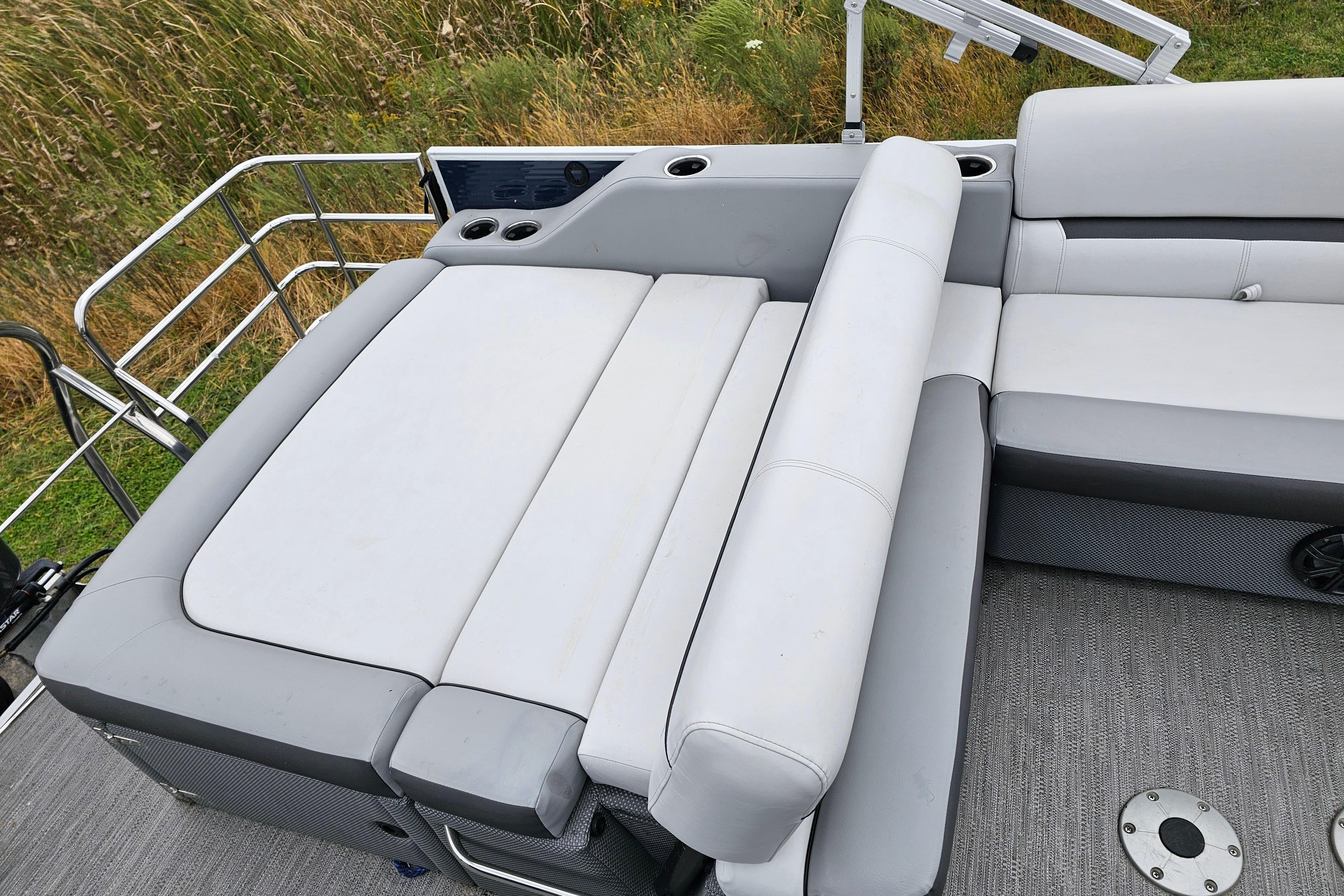 2022 Sweetwater 2286 SFL boat interior with gray seating and cup holders.