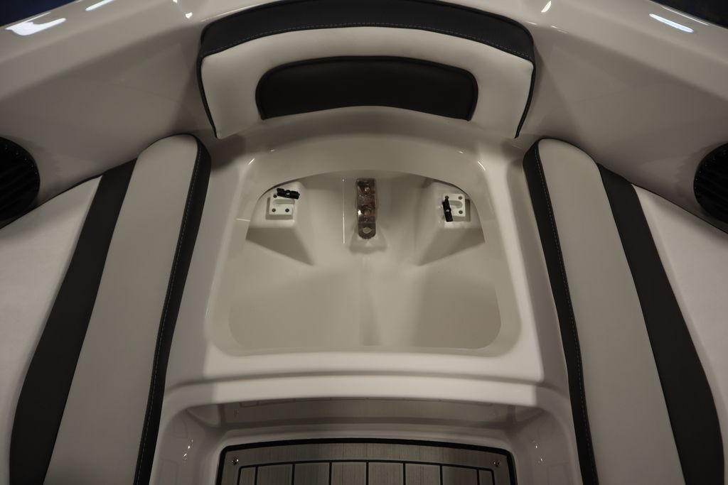 Interior view of 2026 Yamaha Boats 195S, featuring sleek seating and storage area.