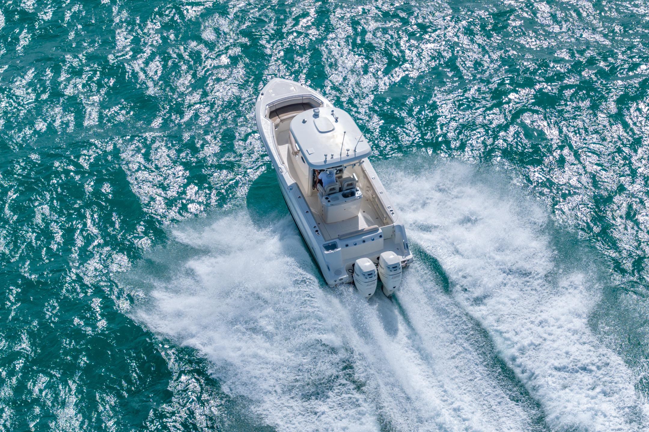 2016 Boston Whaler 280 Outrage cruising on vibrant blue ocean waters.
