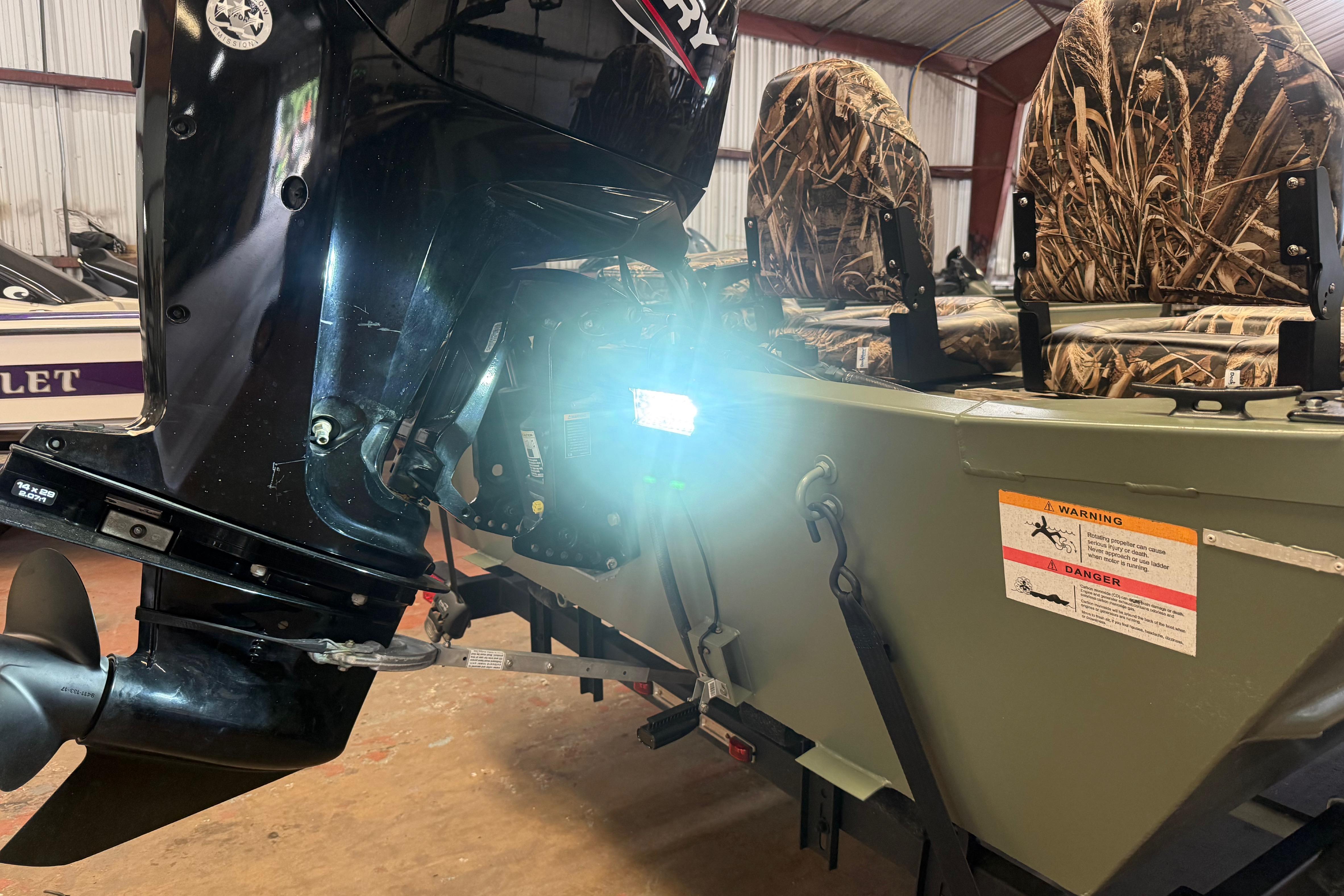 2020 Lowe Roughneck 2070 Big River boat with camo seats and outboard motor.