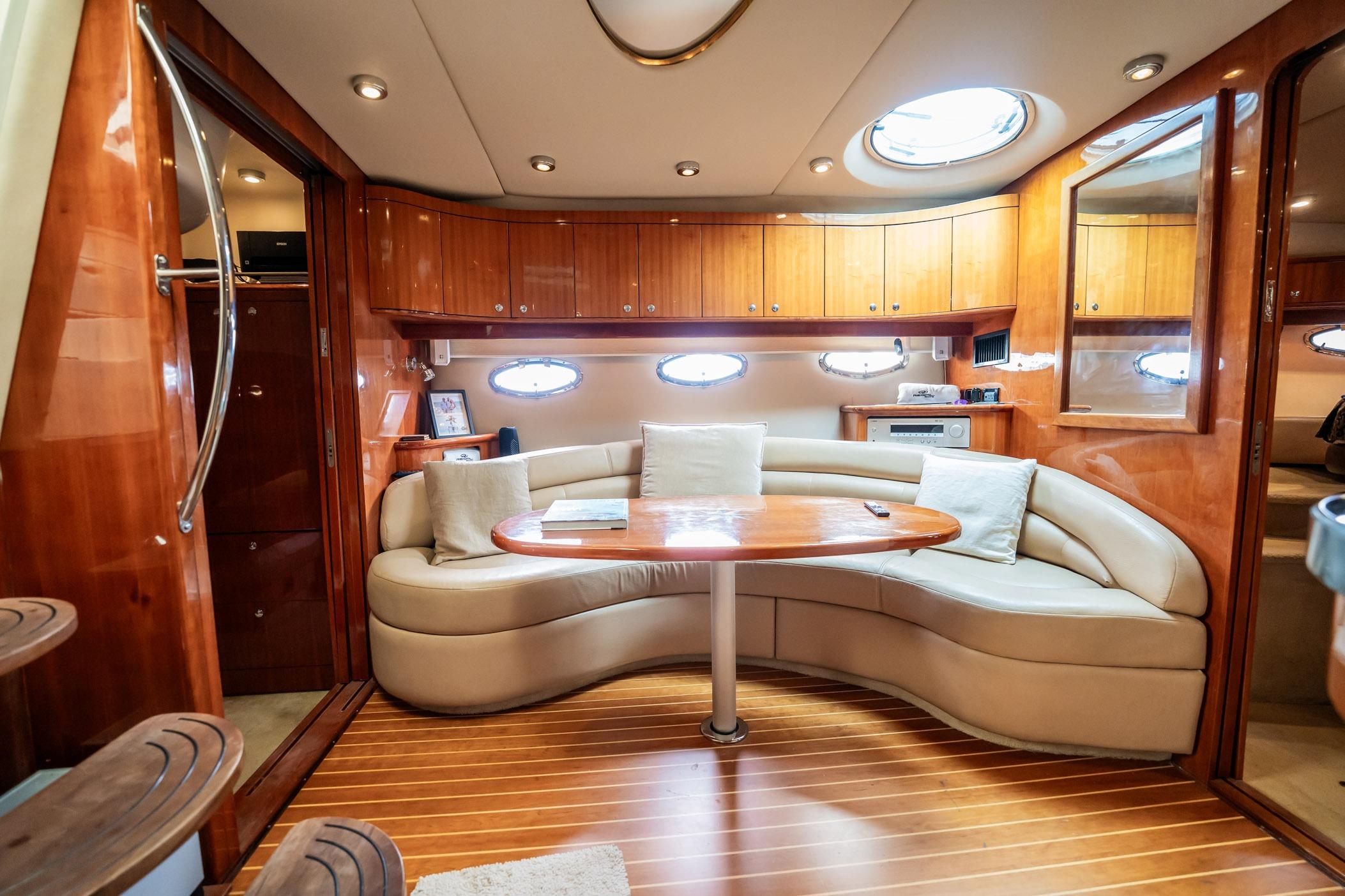 Luxurious 2008 Regal Commodore 4460 yacht interior with elegant wood finishes and plush seating.