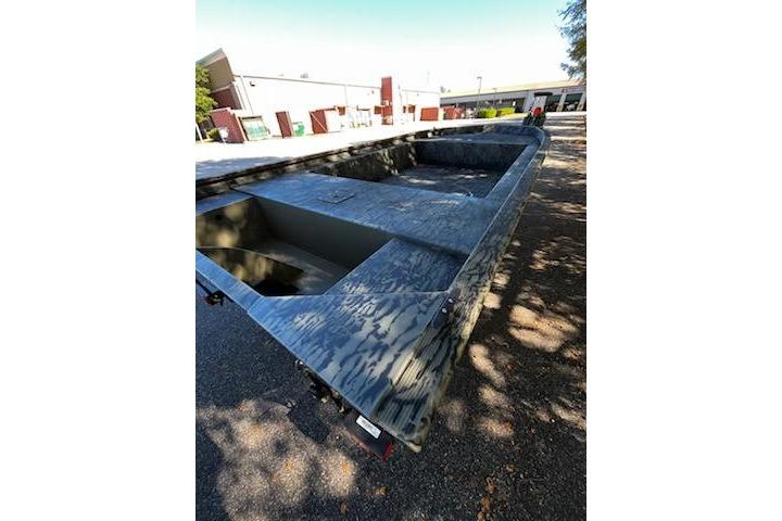 2026 Tracker Grizzly 1754 Utility boat, camo design, parked outdoors.