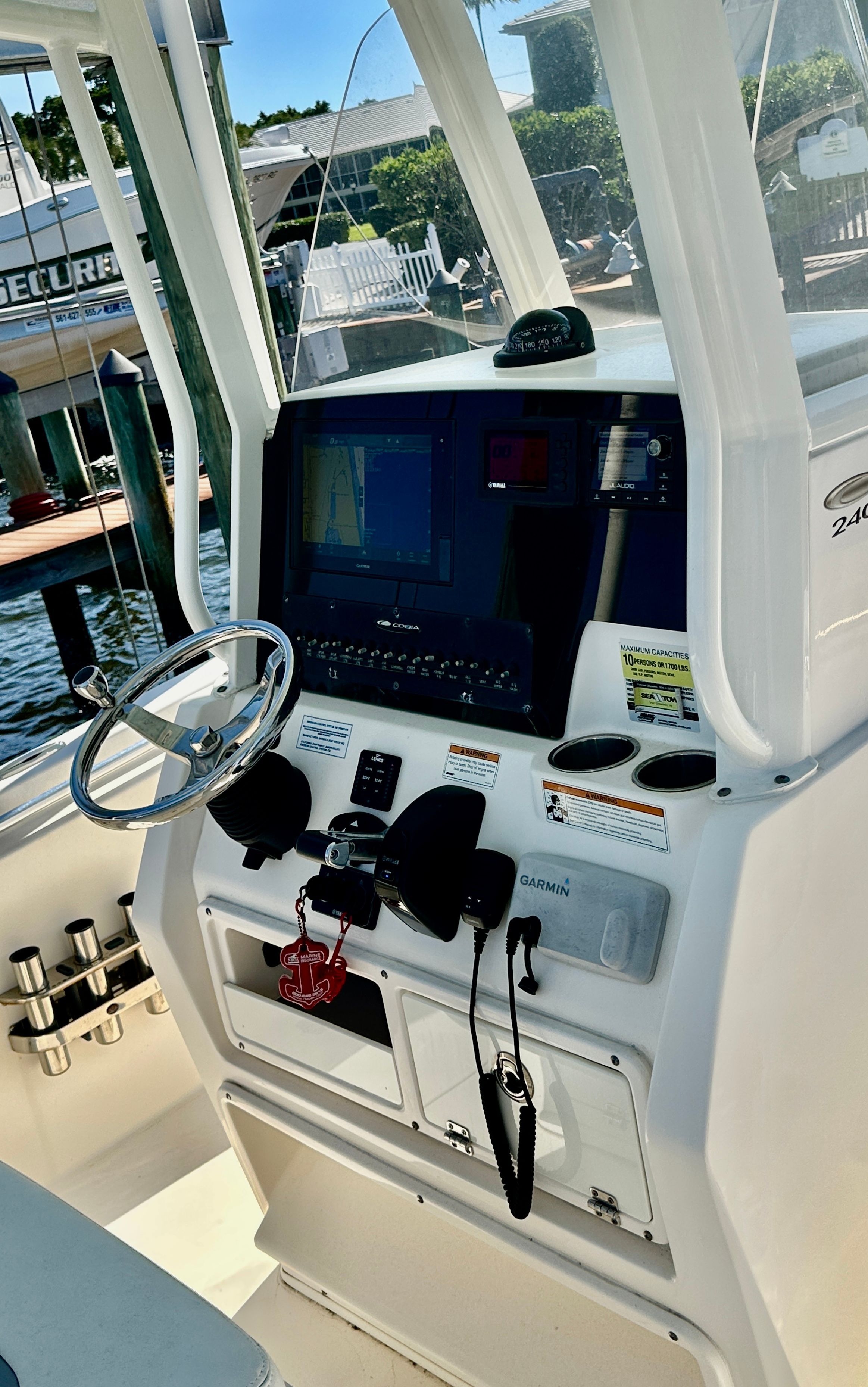 The image shows the helm of a 2022 Cobia 240 Center Console boat with modern instruments.